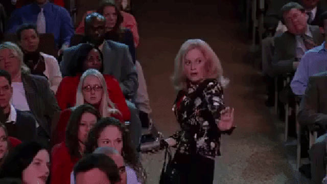 Gif: scene from Mean Girls where Mrs. George is dancing in the audience as she is recording her daughter perform