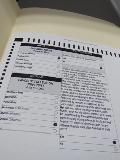 6. Go to the table with cardboard “study carrels” to fill in the circles on your ballot.