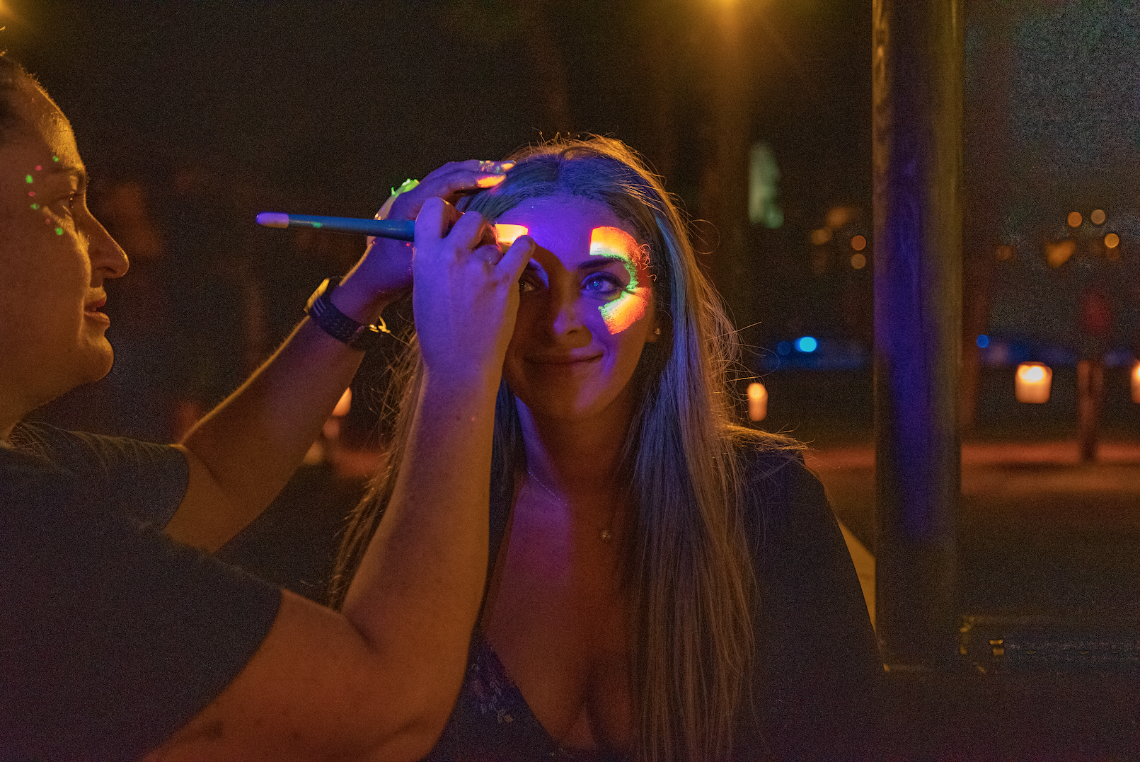Adults Enjoying Face Painting at Wedding