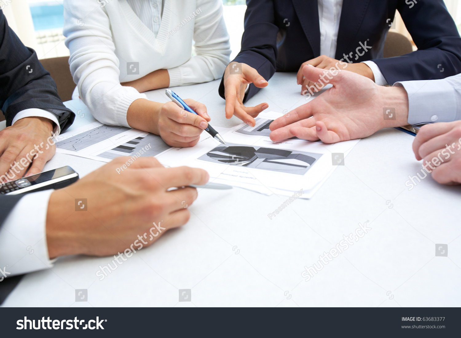 stock-photo-image-of-business-people-hands-working-with-papers-at-meeting-63683377.jpg