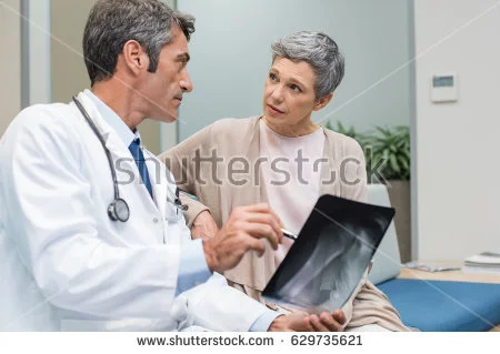 stock-photo-male-doctor-and-senior-patient-discussing-scan-results-at-the-office-doctor-showing-to-senior-629735621.jpg
