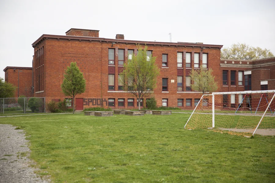 Recent landscape improvements have made the areas outside the school more welcoming for neighbors with seating, newer soccer and playground equipment, and basketball court as shown here from bordering Evans Street.