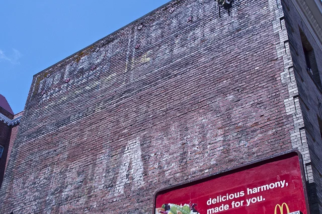 Numerous layered signs at 151 Leavenworth