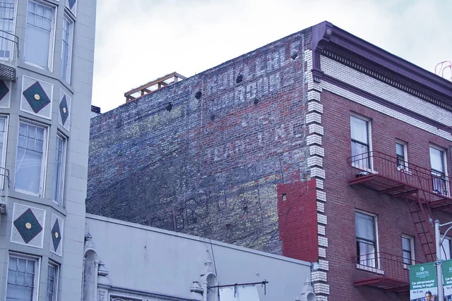 924 Geary. A riot of faded color between two residential buildings on Geary. Two ghost signs are visible here, the lower one the ghostly geometric lines of a Wrigley's Spearmint Gum ad, the other a barely decipherable sign for the Hotel Erle. Less well preserved than it's twin on Polk Street, this Wrigley's ad is nevertheless a great find for the eagle-eyed. A view of the building's backside can be seen here . The hotel was once a brothel .