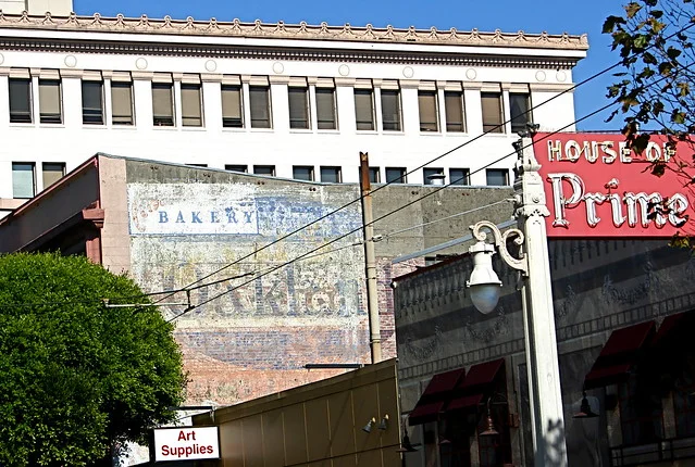 1946 Van Ness. Built in 1920 by MacDonald and Kahn architects as a showroom for the now defunct California-Oakland Motor Company; the building also showcased Kissel, Dueasenberg, Auburn, and Delage automobiles before being decommissioned as a showroom in 1930. From 1938 to 1990 the building was the site of Ahren's Brothers Pie (later renamed Ahren's Bakery and Coffee shop and finally Ahren's Bakery and Restaurant). The building has been abandoned since Ahren's closed. Want to learn A LOT about the various automobiles sold in this building and/or see historical photos? Read this PDF from the SF Planning Department. I <3 Historical Reports. http://www.sfplanning.org/ftp/files/notice/2011.0562U.pdf