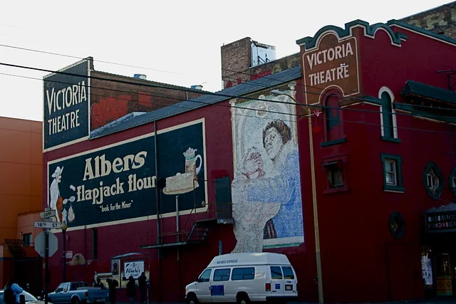 2961 16th. Lots of refurbished signs on the side of this old theater. Built in 1908 as a vaudeville hall, The Victoria has also operated under the names Brown's Opera House, El Teatro Victoria, and New Follies Burlesk. Historical photo from 1968. Notice that the That Good 44 2 for 15¢ sign was not restored. Info on it's historical status .