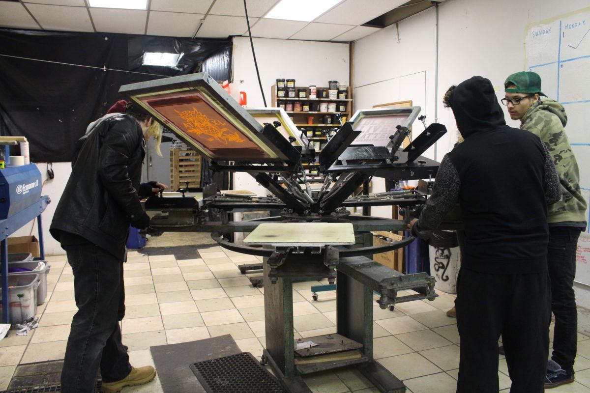 Youth apprentices build the screen printing press.