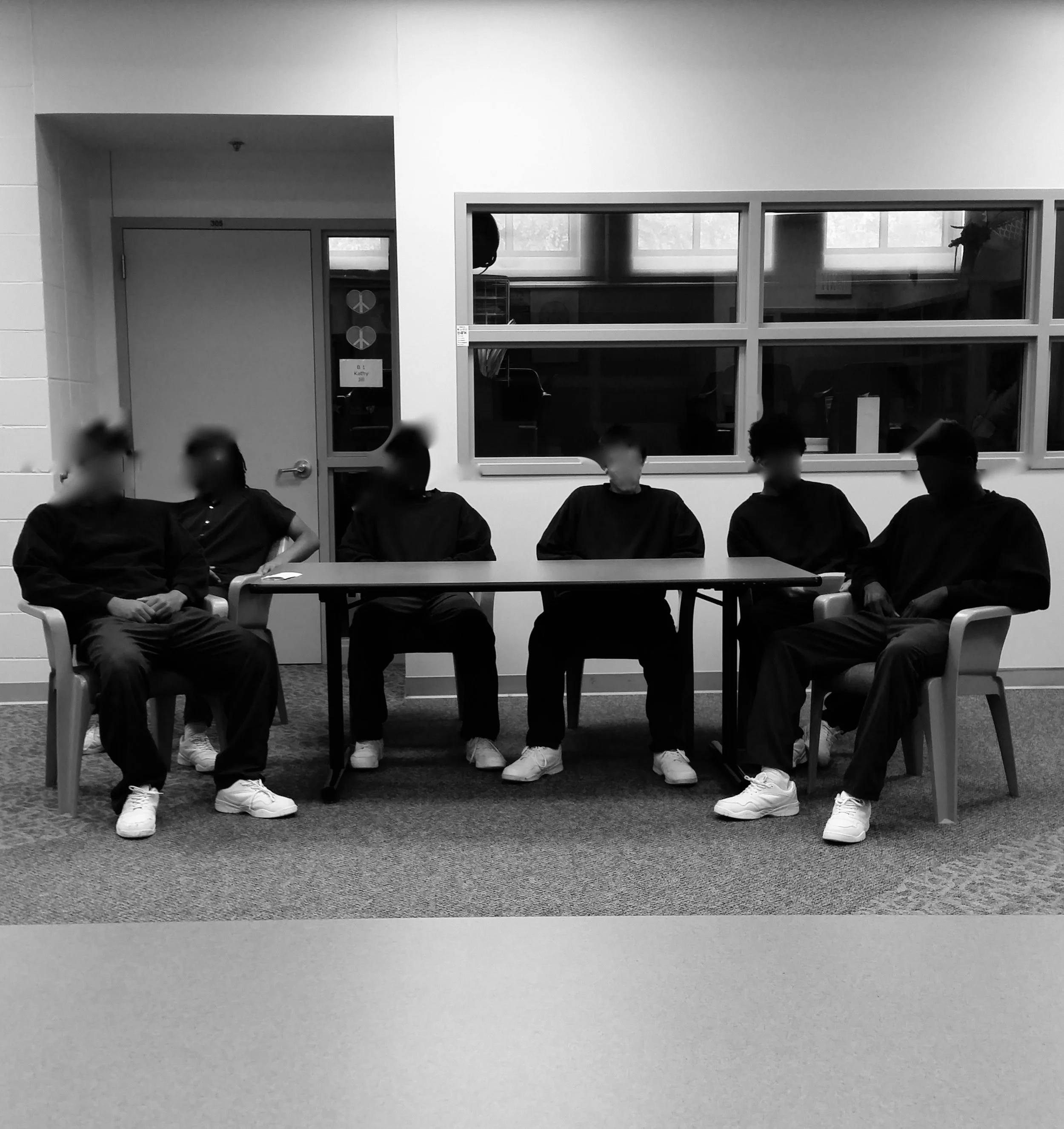 Youth workshop in Des Moines, IA Detention Center. (Faces blurred for anonymity.)