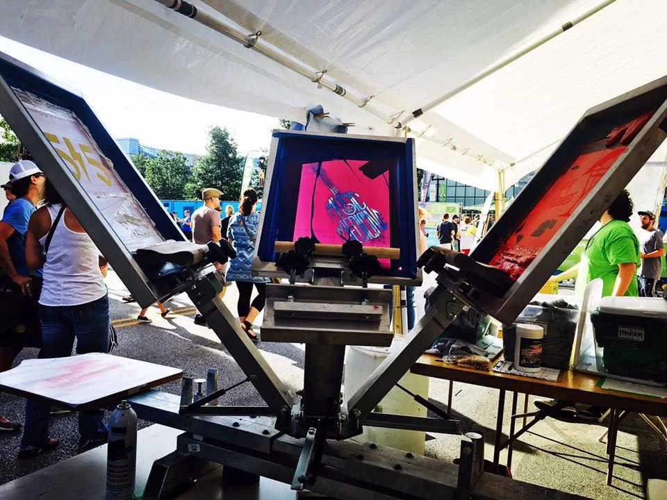 ArtForceIowa’s mobile screenprinting unit advertising the SctreetCred Studios program at music festival 80/35 . (2015)