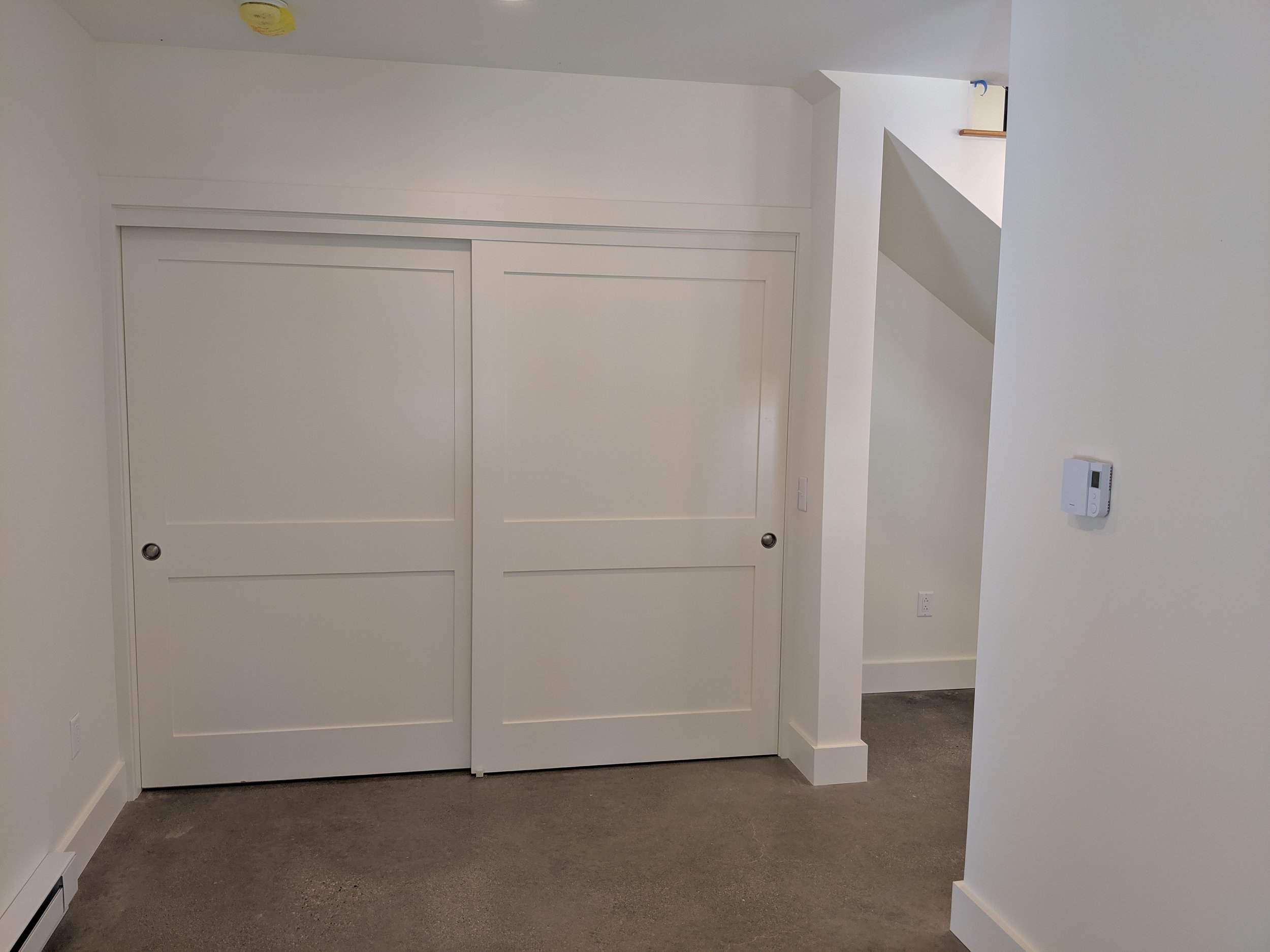 8' Bypass Solid core Doors with Poplar Trim, Polished Concrete Floors