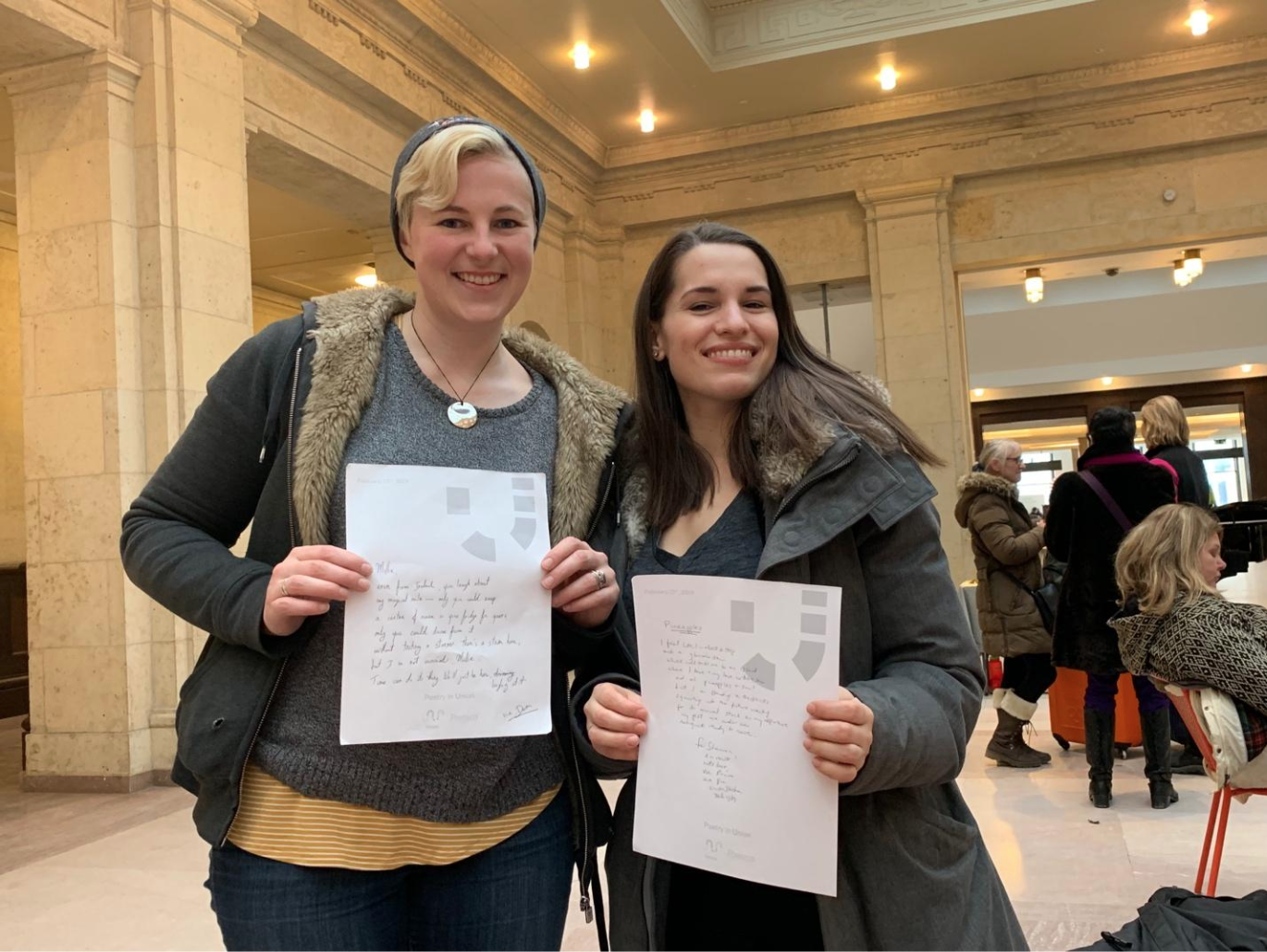 Hannah Martin, left, with her company co-owner Shannon Litt, right, posing with their poems at the event. (CanCulture/Alexander Sowa)
