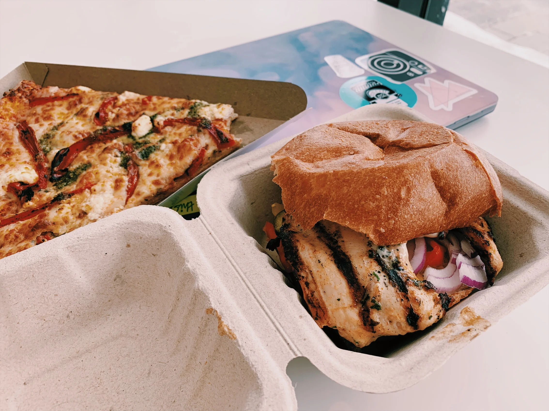 The Flavoursome Grill halal chicken burger and a cheesy pizza slice from the Service Hub Cafe at Ryerson University. (CanCulture/Akanksha Dhingra)