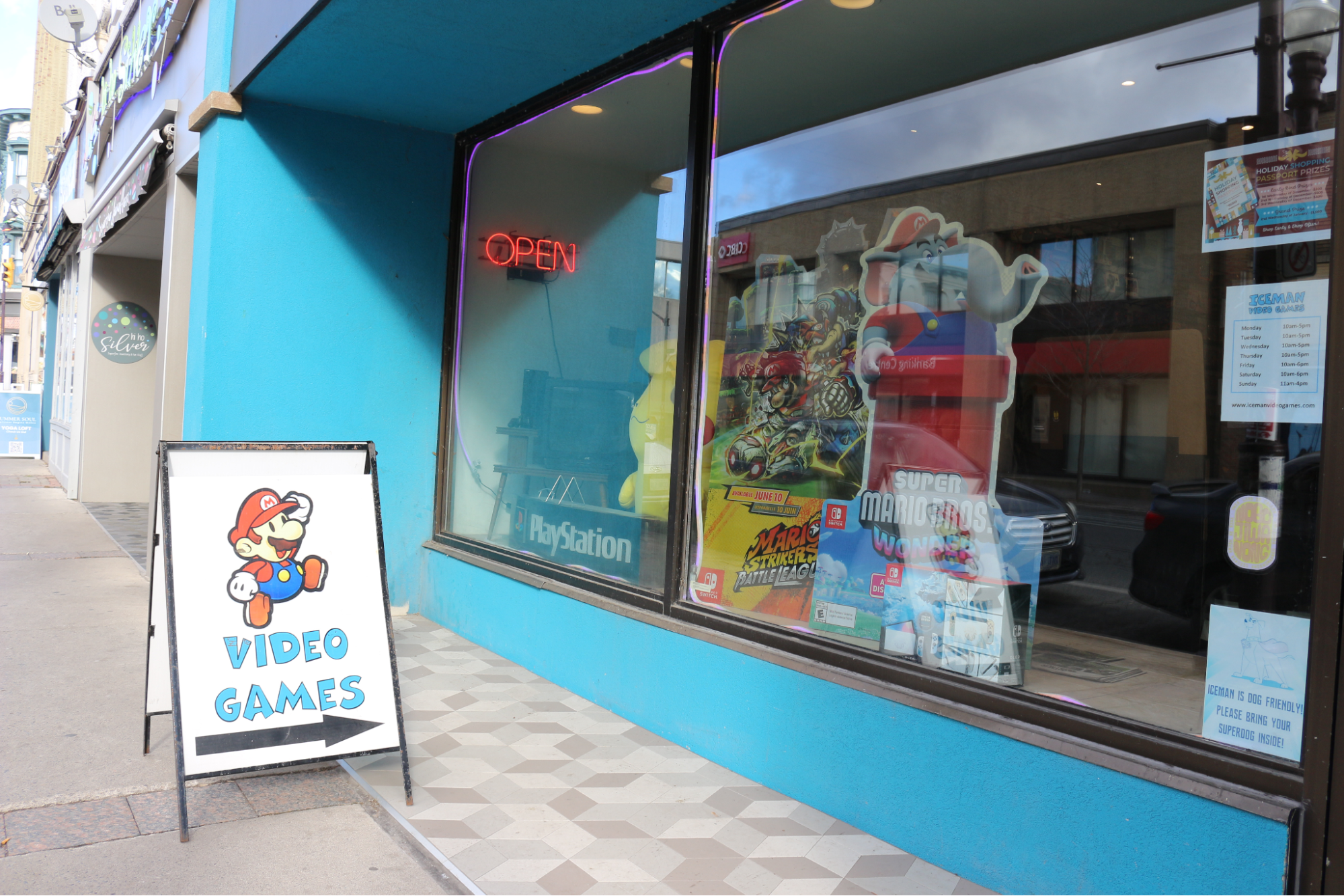  Iceman Video Games outdoor sign points towards the storefront. 