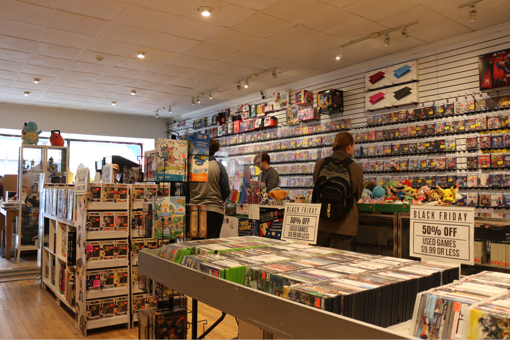  Customers look at products around the store with more Iceman Video Games products behind them. 