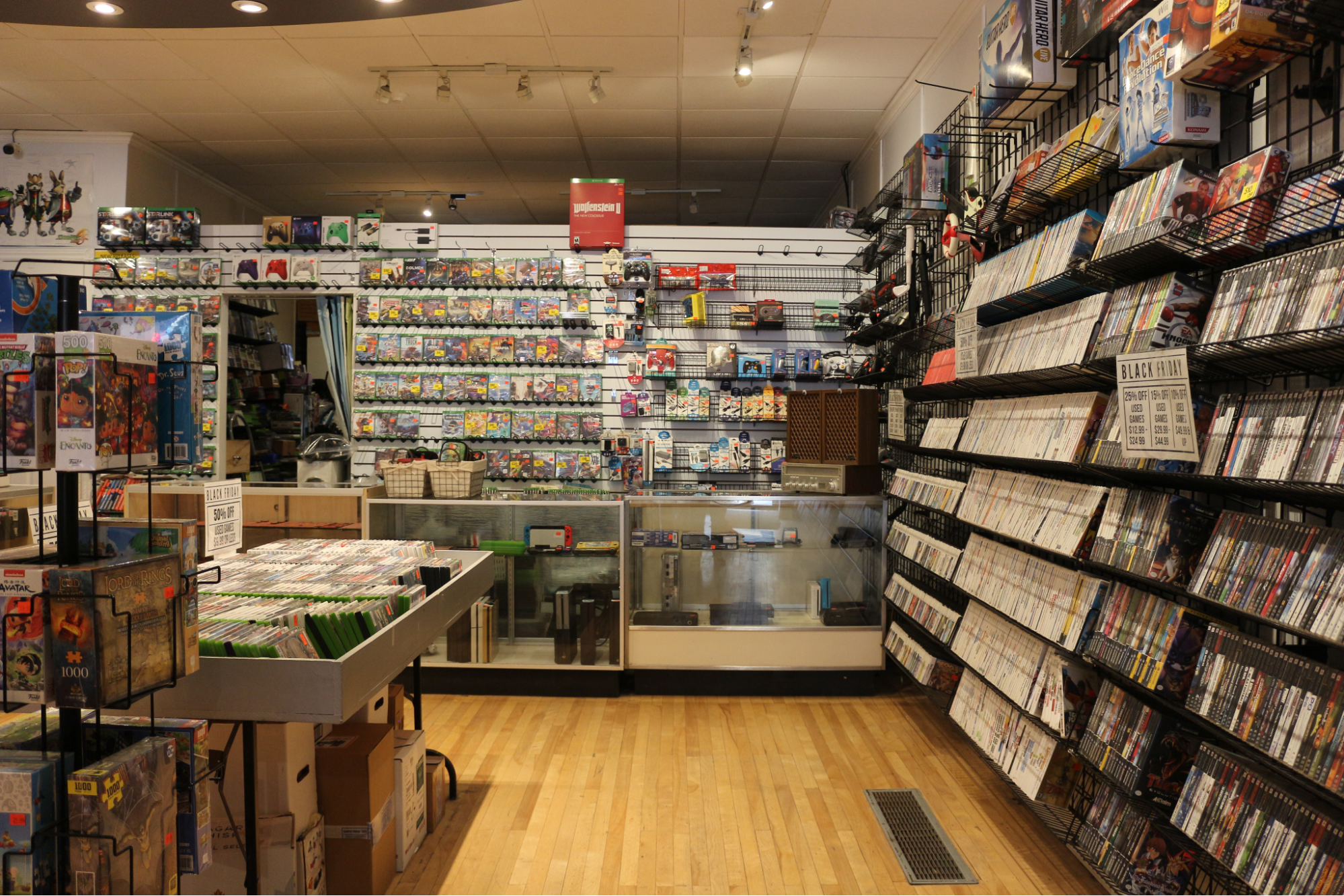 Iceman Video Games store with game cases lining the walls and toy collectible&nbsp;merchandise in the middle of the store. 