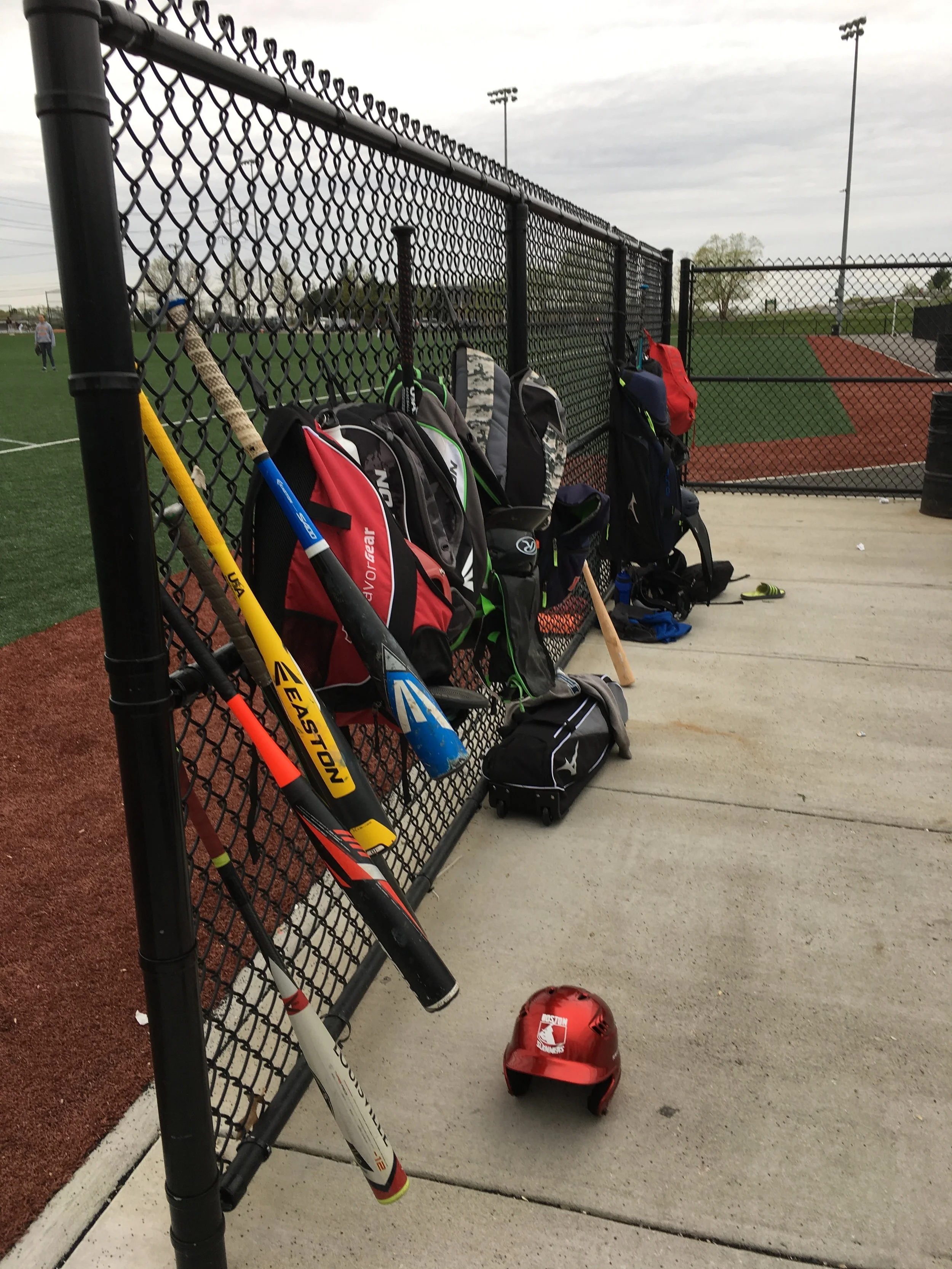 The girls' bats, backpacks and batting helmet.