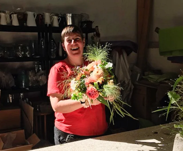 Photo by Leslie of me enjoying bouquet making with lots of lovely customers in my barn at my open day