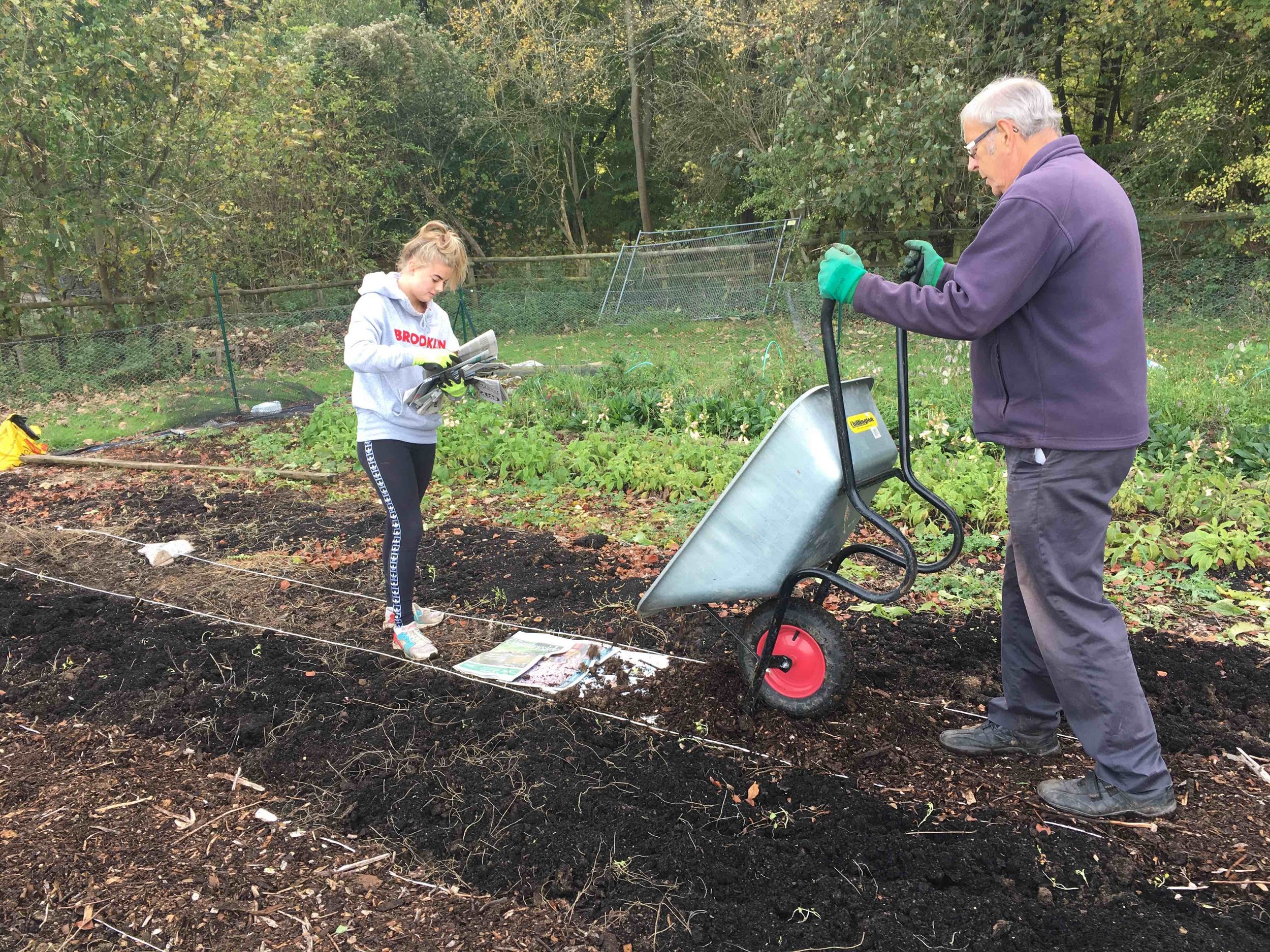 Dad and Emma making paths.jpg