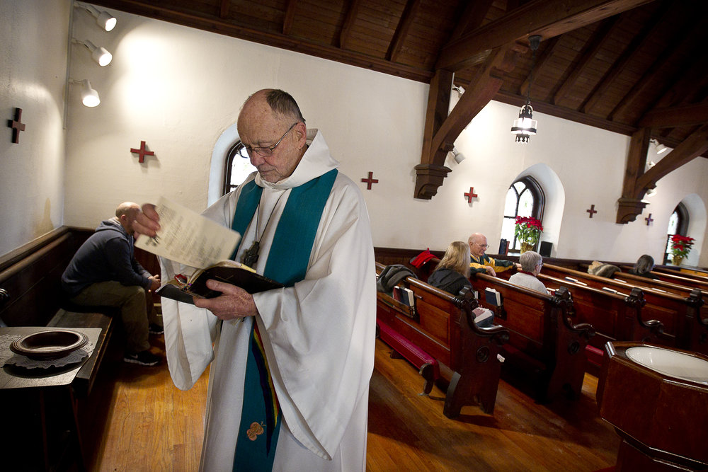  NORTH LAKE, WI — JANUARY 18, 2015: Reverend David Couper prepares his verses before mass at St. Peter’s Episcopal Church, Sunday, January 18, 2015. 