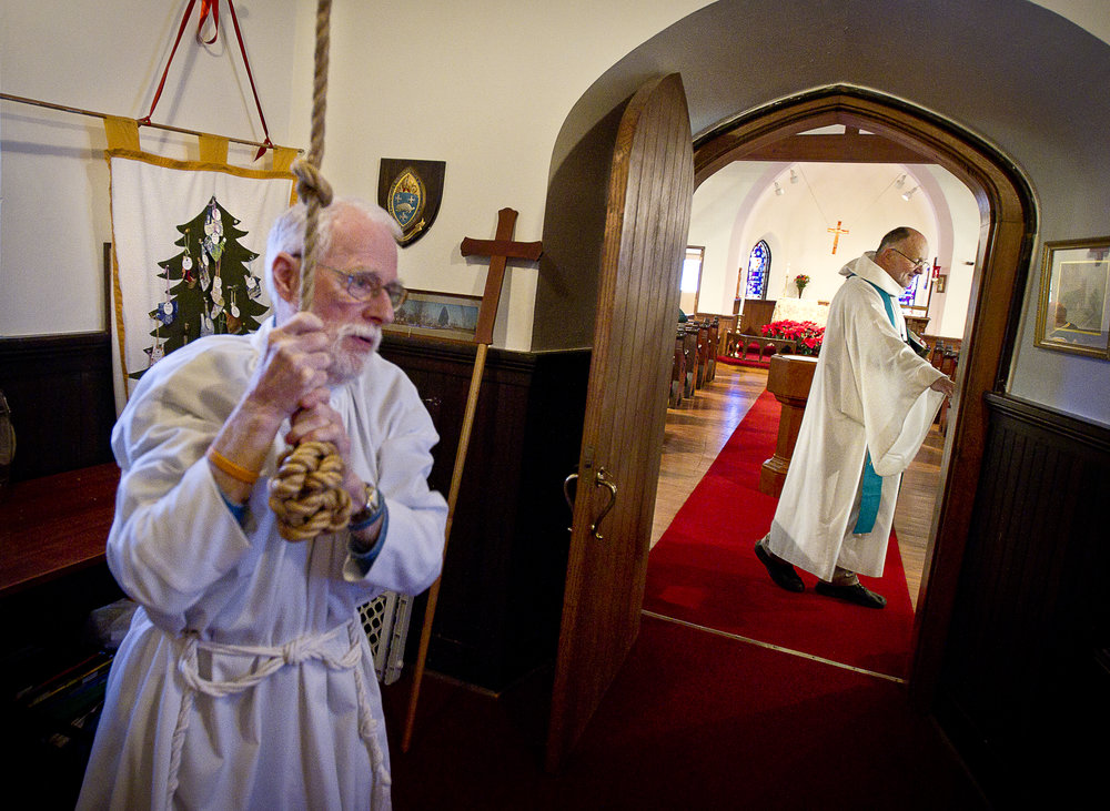  NORTH LAKE, WI — JANUARY 18, 2015: Reverend David Couper prepares for mass as junior warden Peter Buerosse rings the bells at the St. Peter’s Episcopal Church, Sunday, January 18, 2015. 