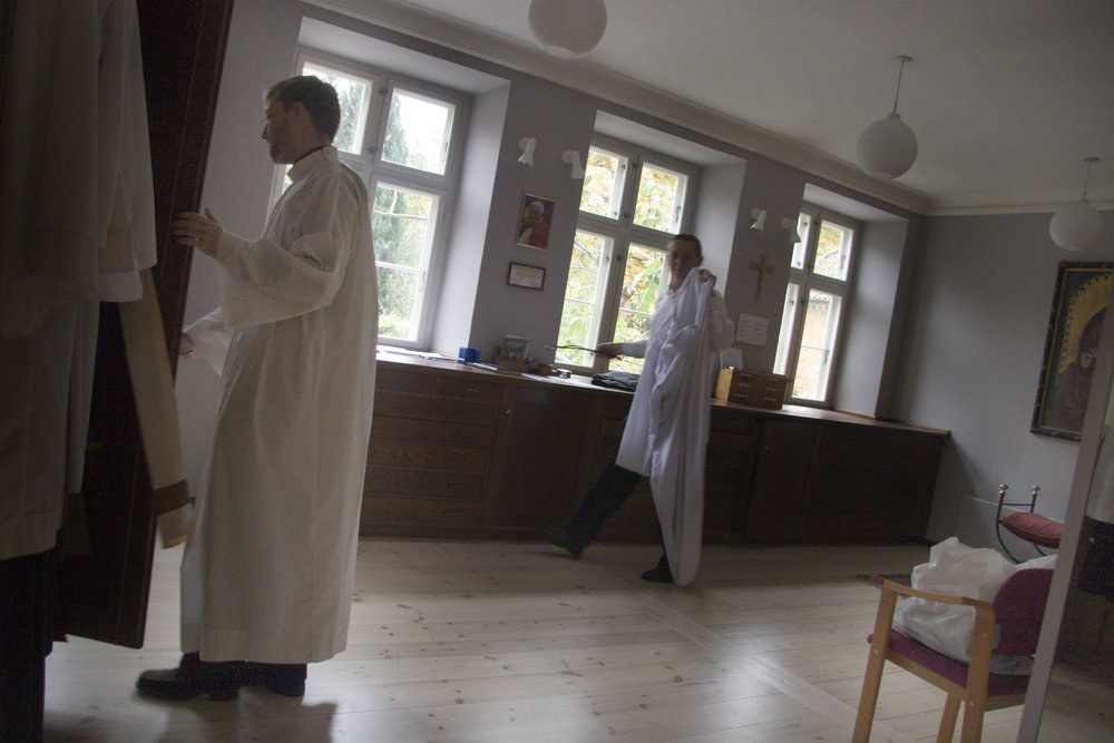  Daniel Nørgaard, left, puts on his robes before mass at Sankt Ansgar’s Cathedral in Copenhagen. 