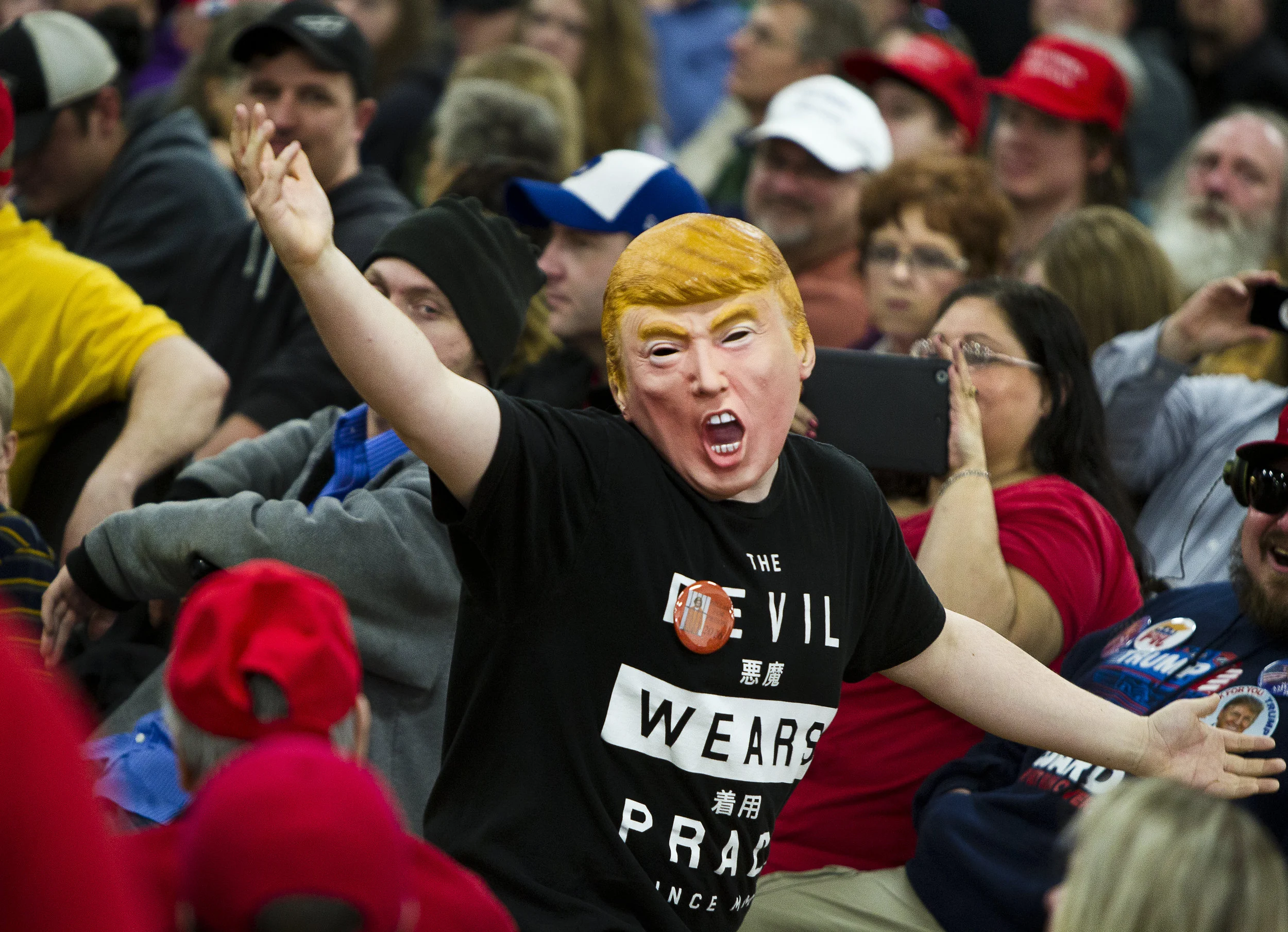 A masked Donald Trump supporter dances before the Republican U.S. presidential candidate arrived at a campaign town hall event in Wausau, Wisconsin April 2, 2016. REUTERS/Ben Brewer