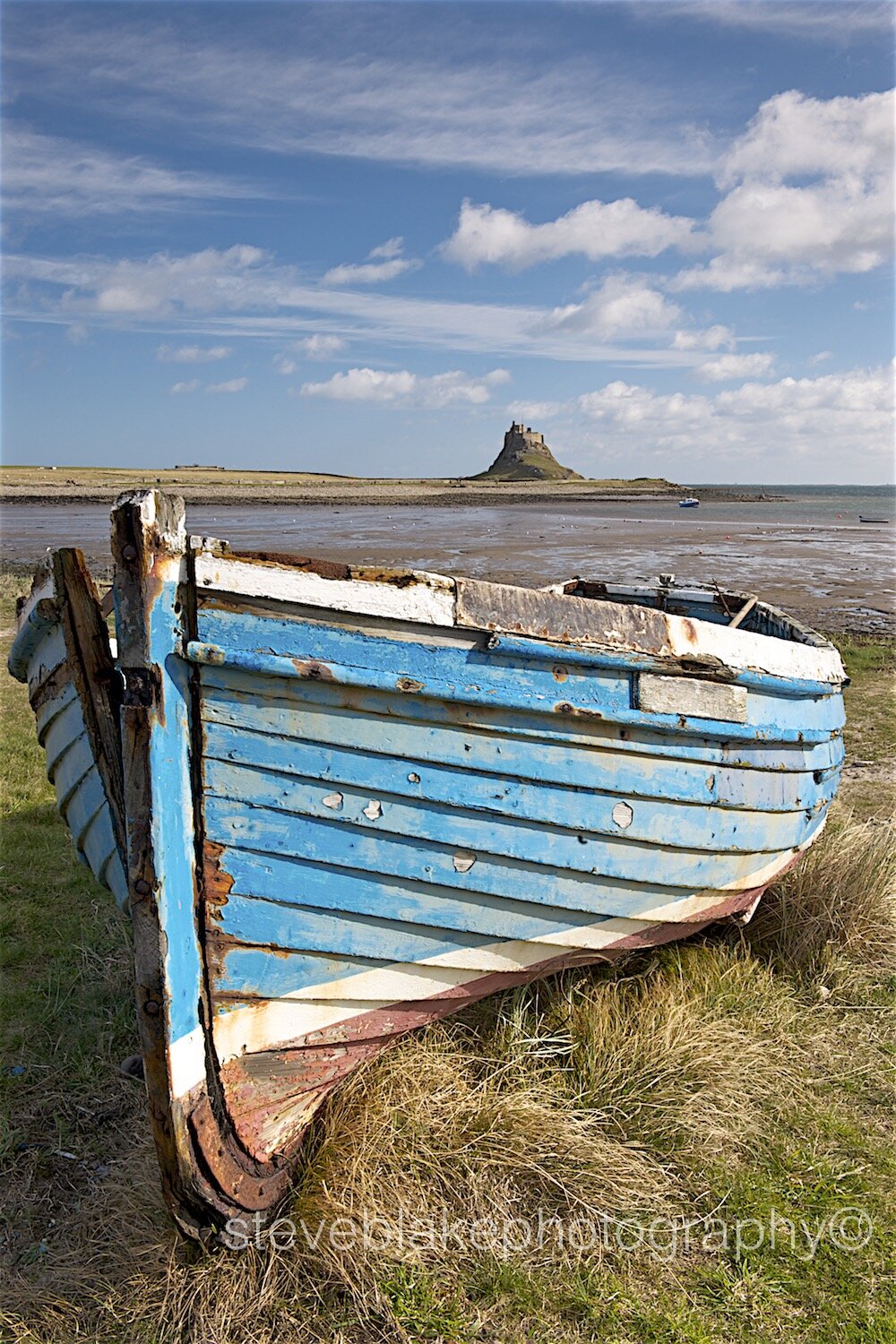 Old fishing boat with Lindisfarne Castle.jpg