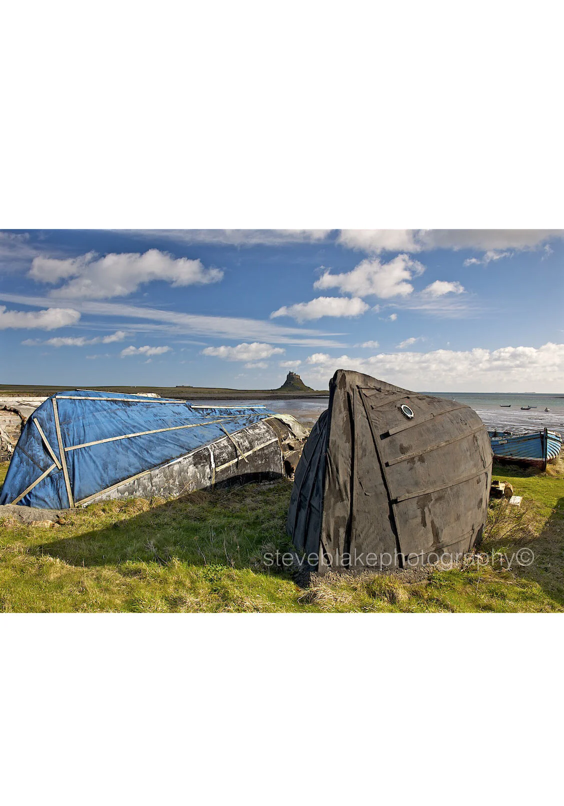 Upturned fishing boats and Lindisfarne Castle..jpg