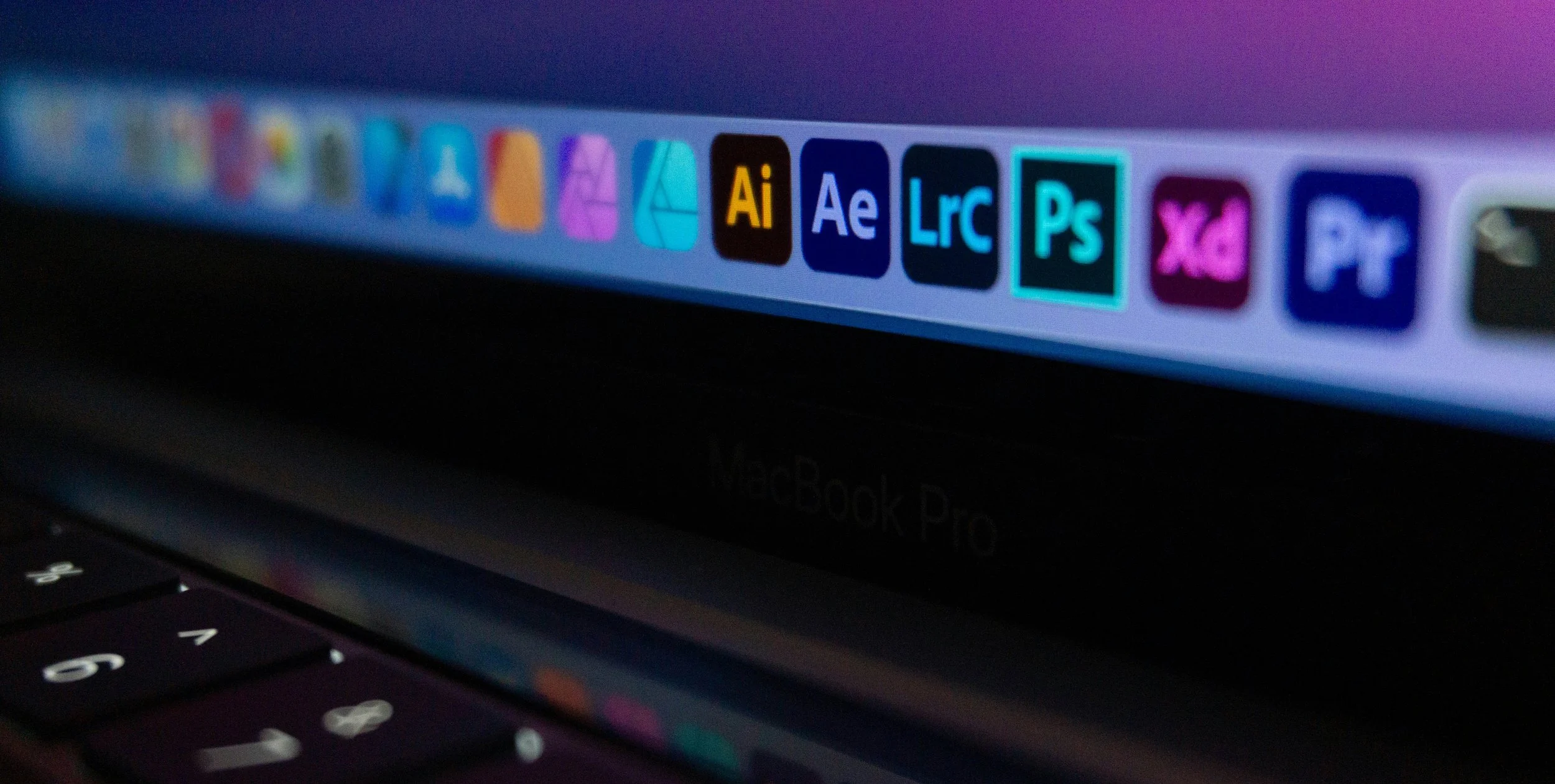 Showing a mac desktop dock with Adobe Illustrator, Photoshop, XD and other apps