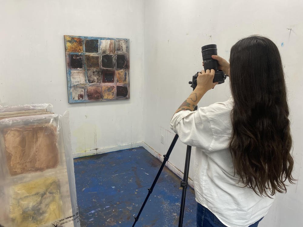  Stephanie Artuso photographing an abstract painting from Deb Chaney's studio, camera on tripod. 