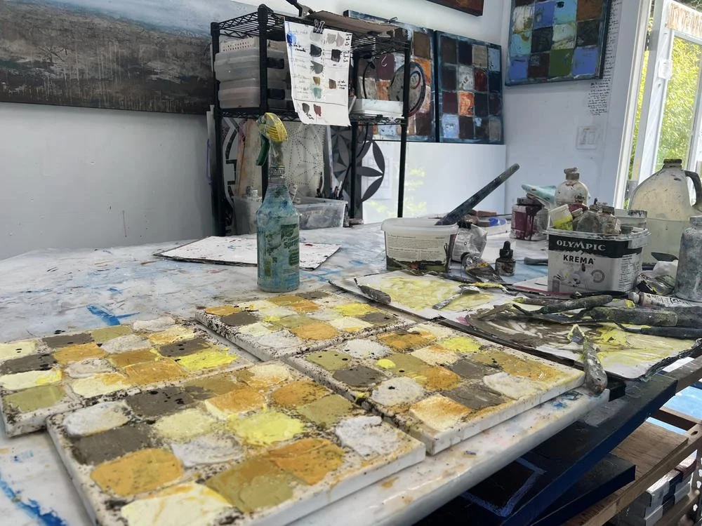 Small color and mixed media studies on studio table by artist Deb Chaney
