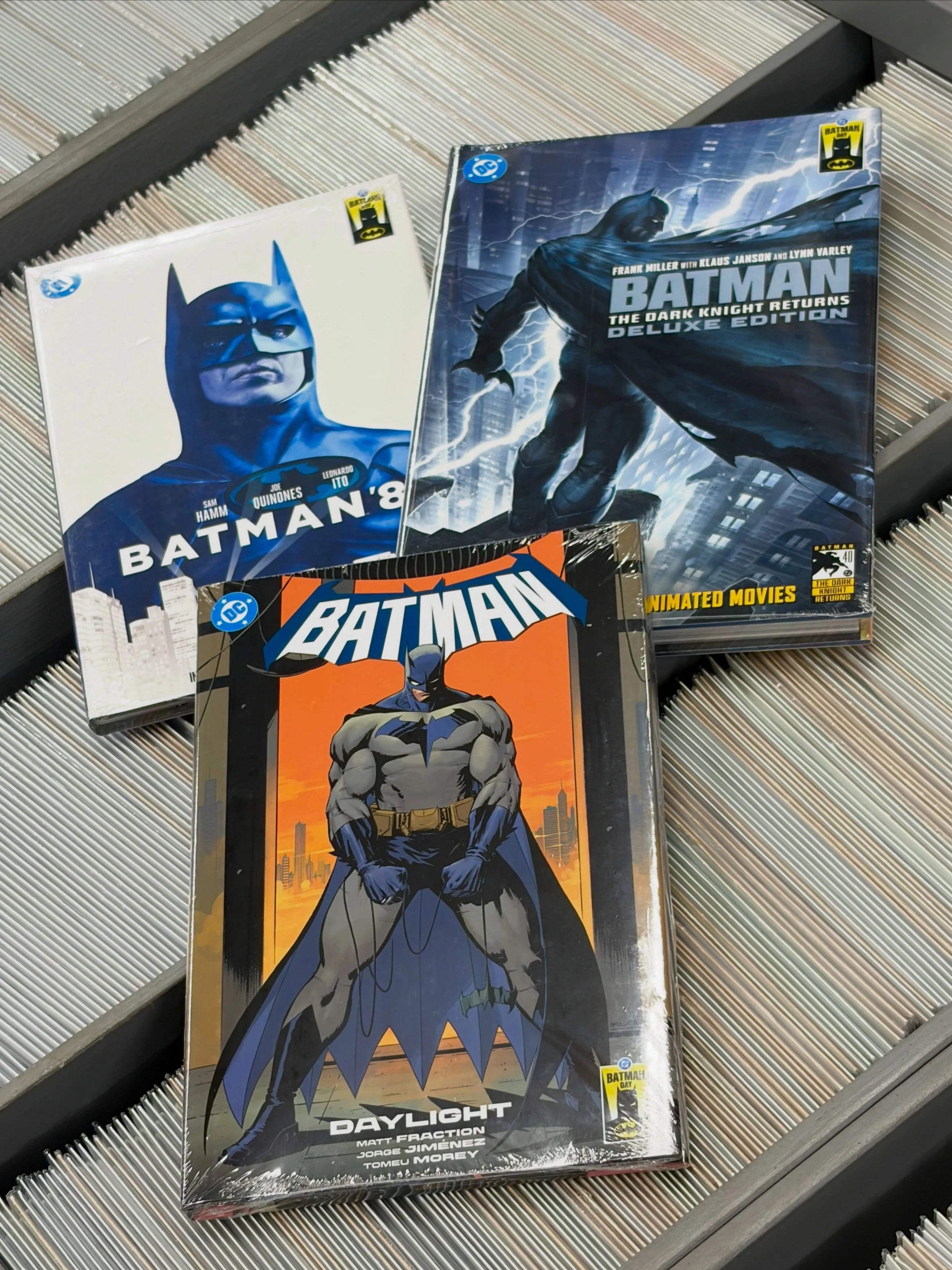 This Saturday is Batman Day! That&rsquo;s the day we celebrate the Caped Crusader even more than we usually do. That means exclusive hardcovers like the ones pictured, including some with digital codes for movie adaptations! That means the release of