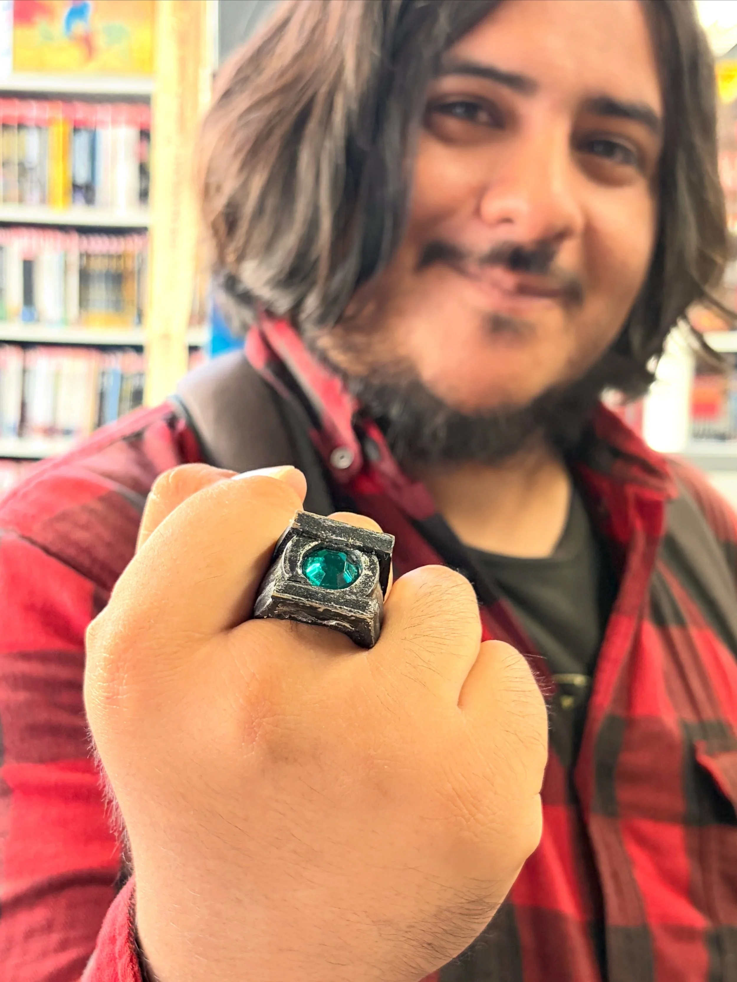 Badass DIY Green Lantern ring spotted at the register on New Comic Book Day! Said that he used a Blackest Night era promo ring as the base, reinforcing it with popsicle sticks before painting it and adding the emerald. Classy accessory for an &ldquo;
