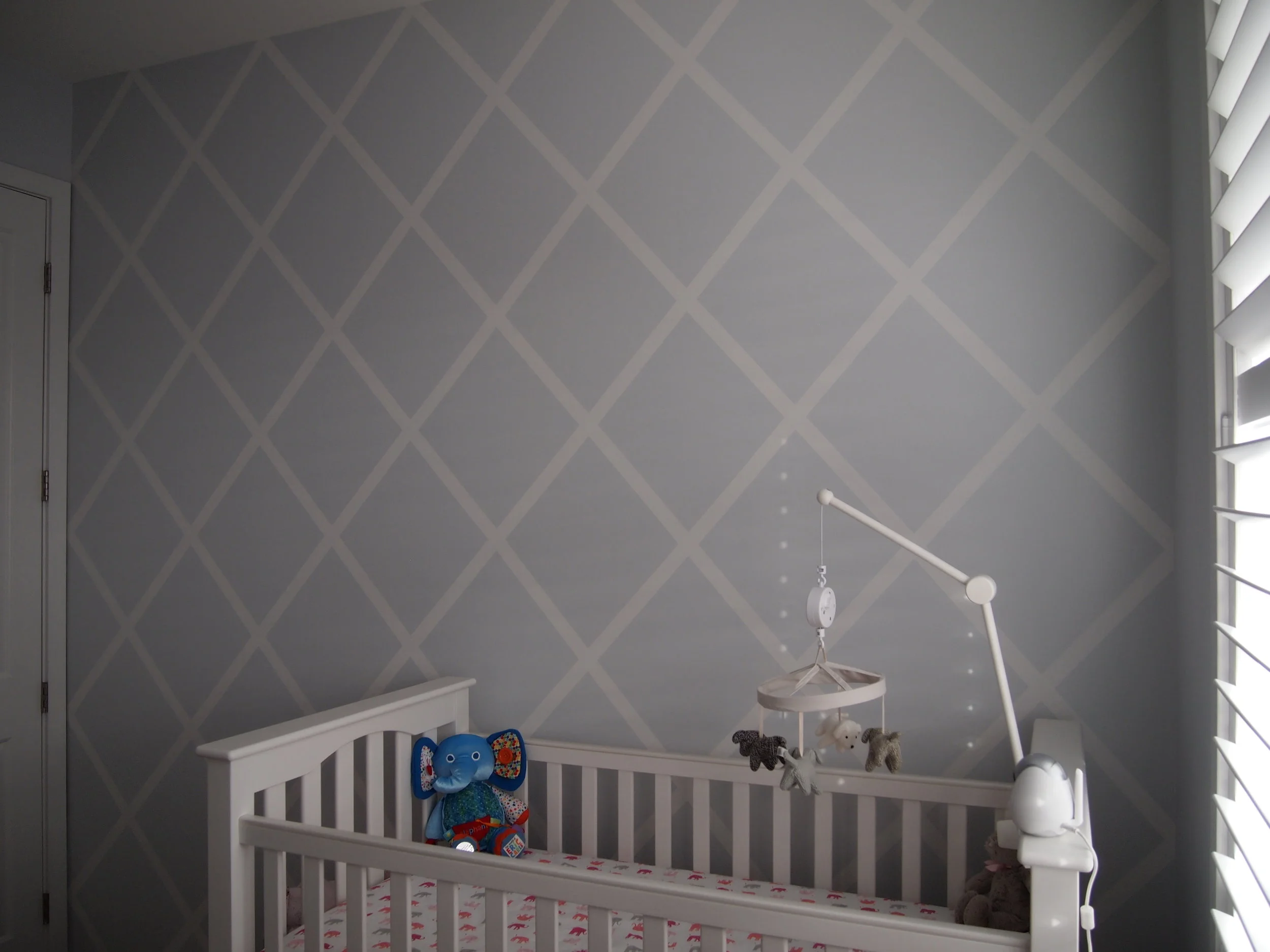  The simple diamond design in this nursery is understated and soft. It gives this room the feeling of a fabric or upholstery surface . 