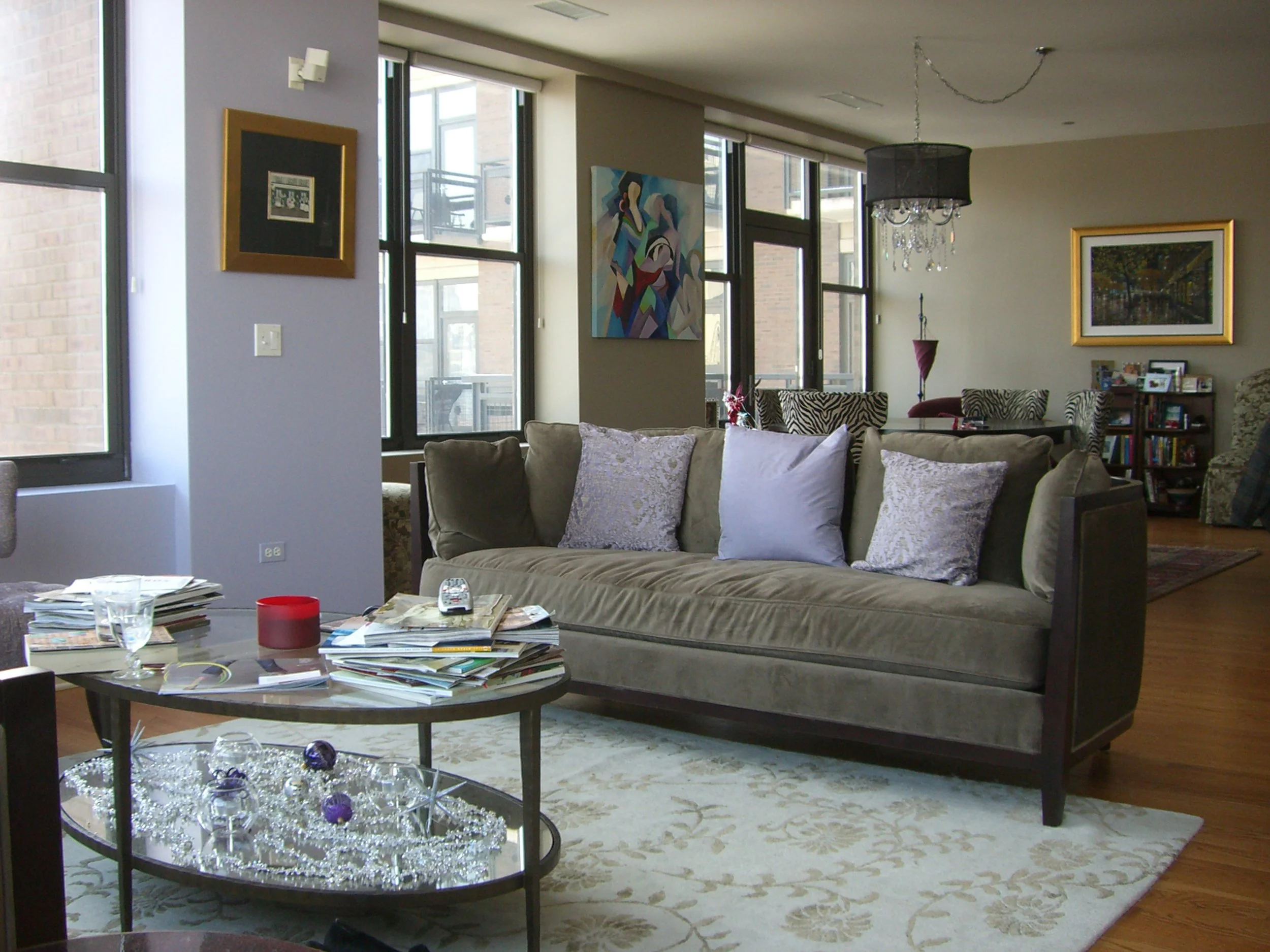  This is a good example of using color to separate function within an open plan floor design. A change in color indicates the transition of the living area into the dining area in a space that does not have an actual wall. Here, a purple hue surround