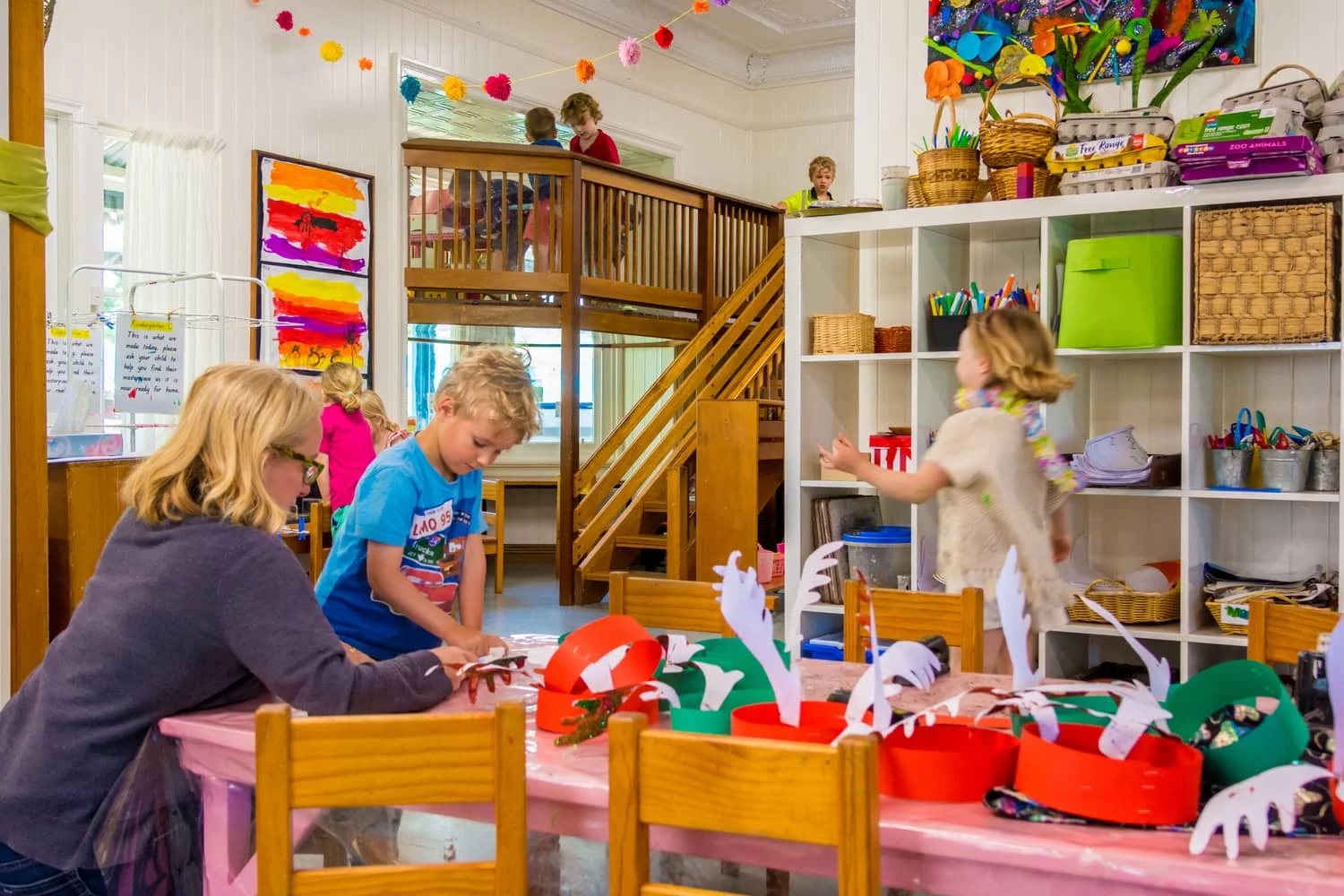 Chiselhurst classroom with wooden staircase to inside loft and children making craft