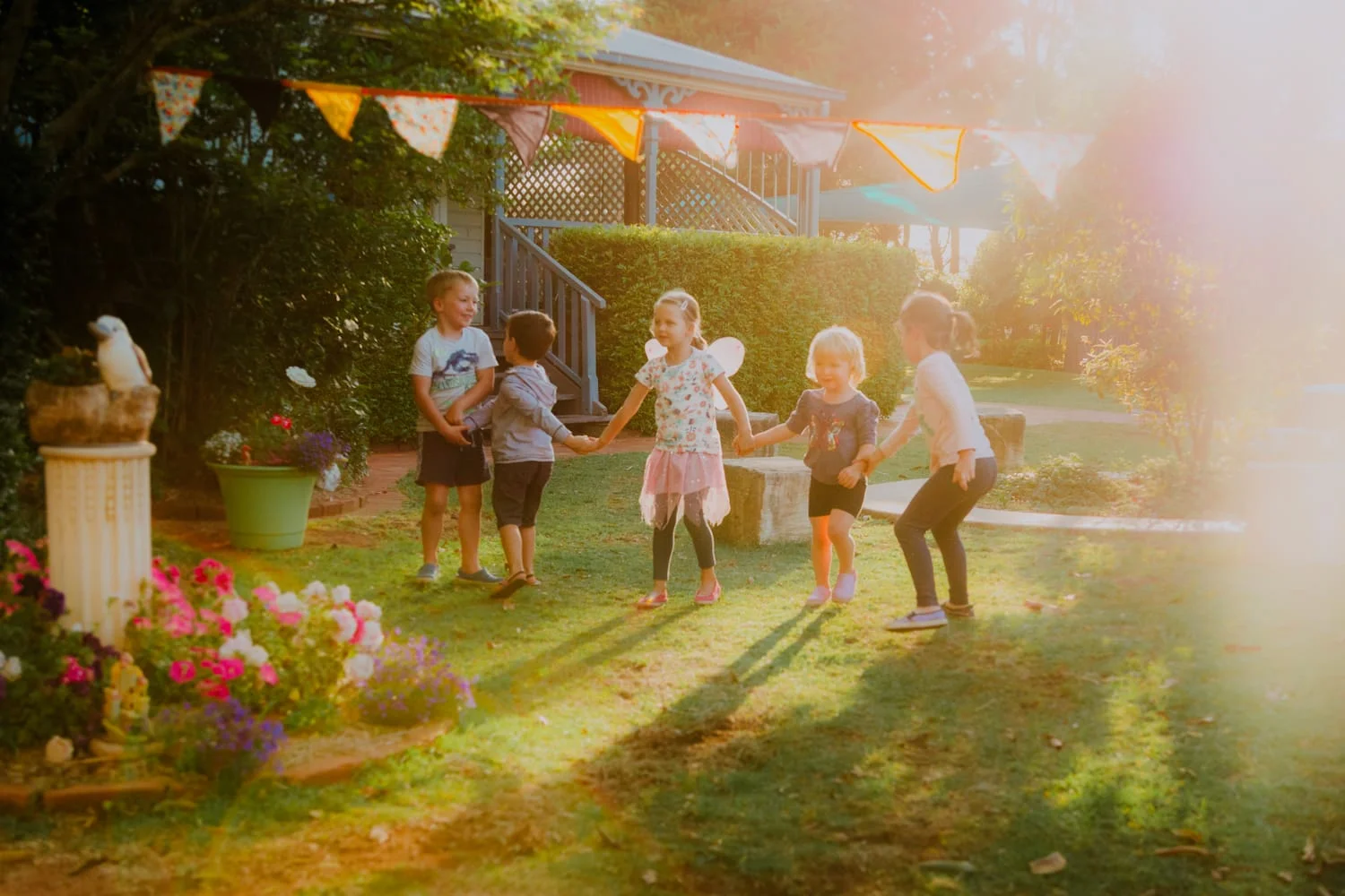 Chiselhurst Kindy Toowoomba front garden in the afternoon children holding hands playing