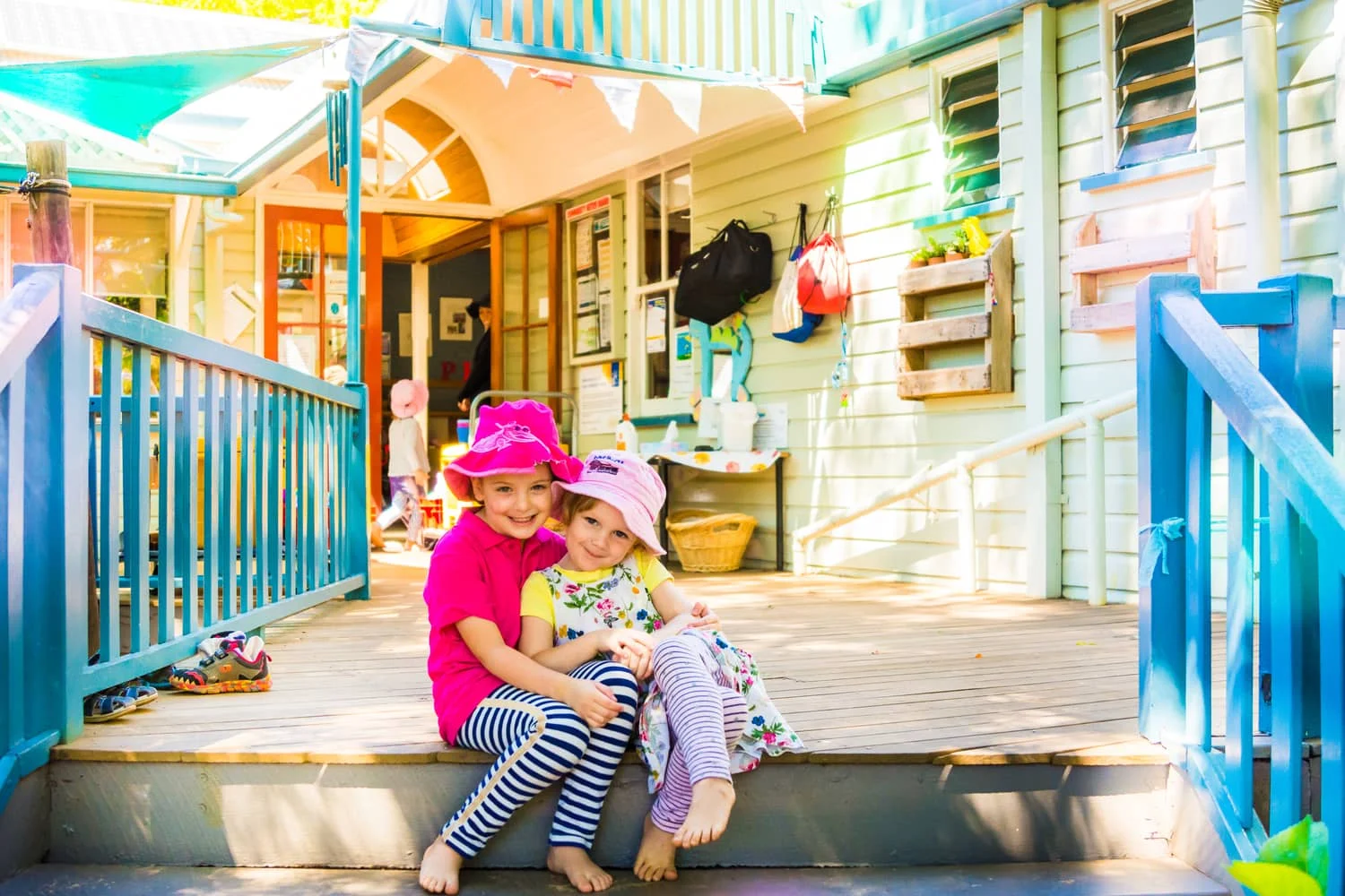 Chiselhurst friends sitting on steps near the kindergarten entrance