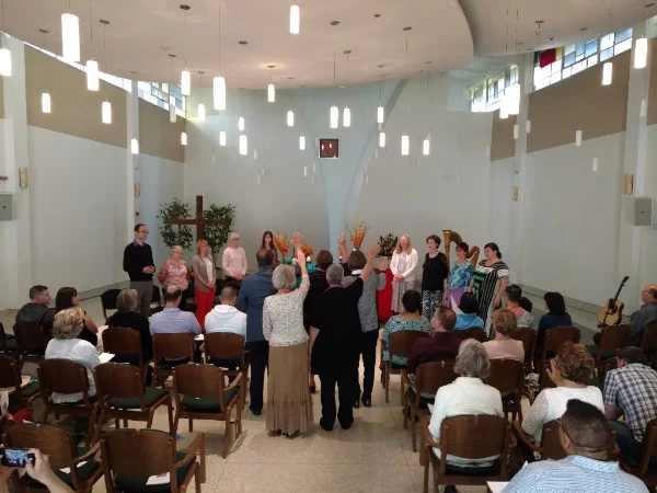 The new graduates receive a blessing from their mentors at the ASD Graduation on May 21, 2016.
