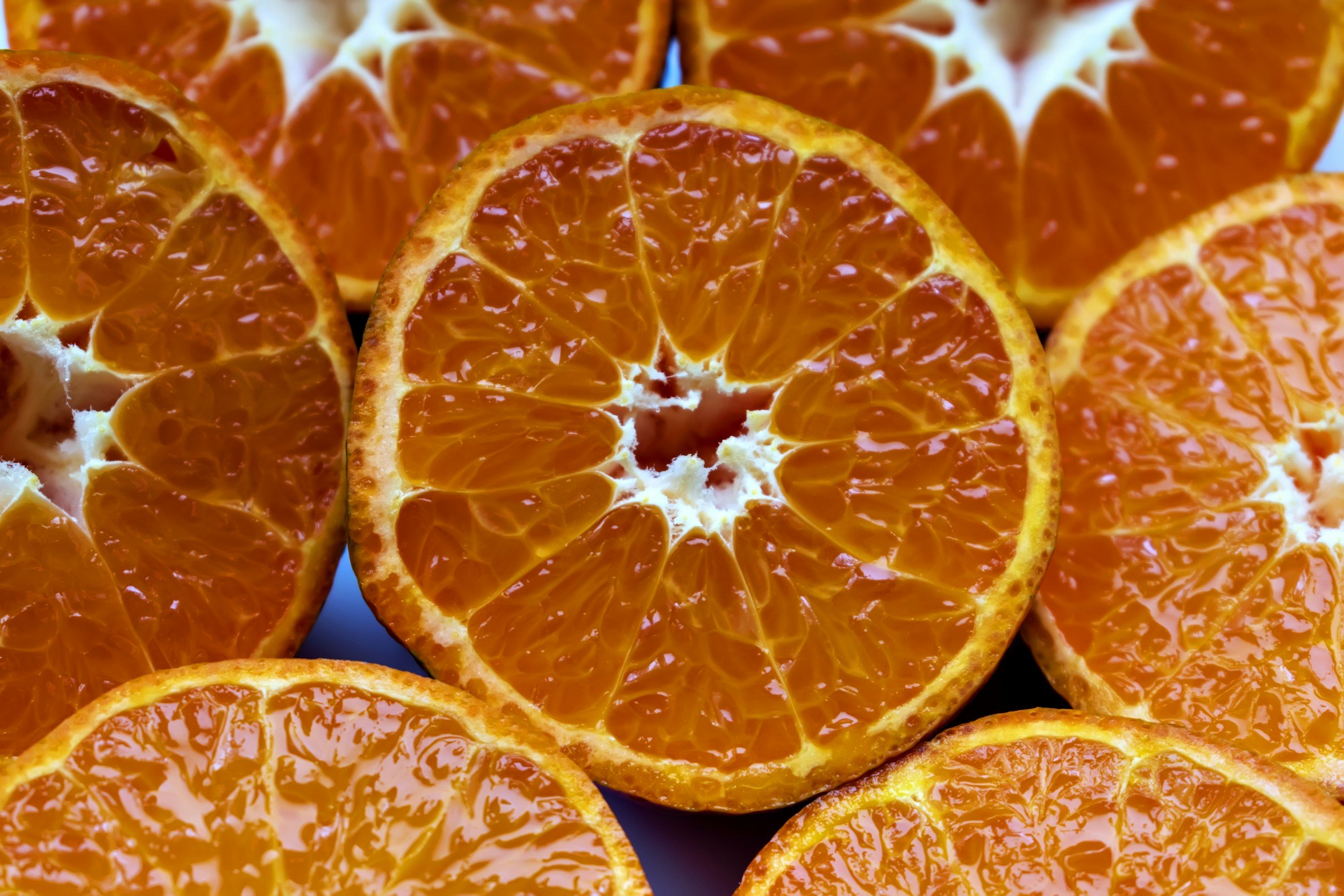 A closeup of an orange slice with other oranges around it