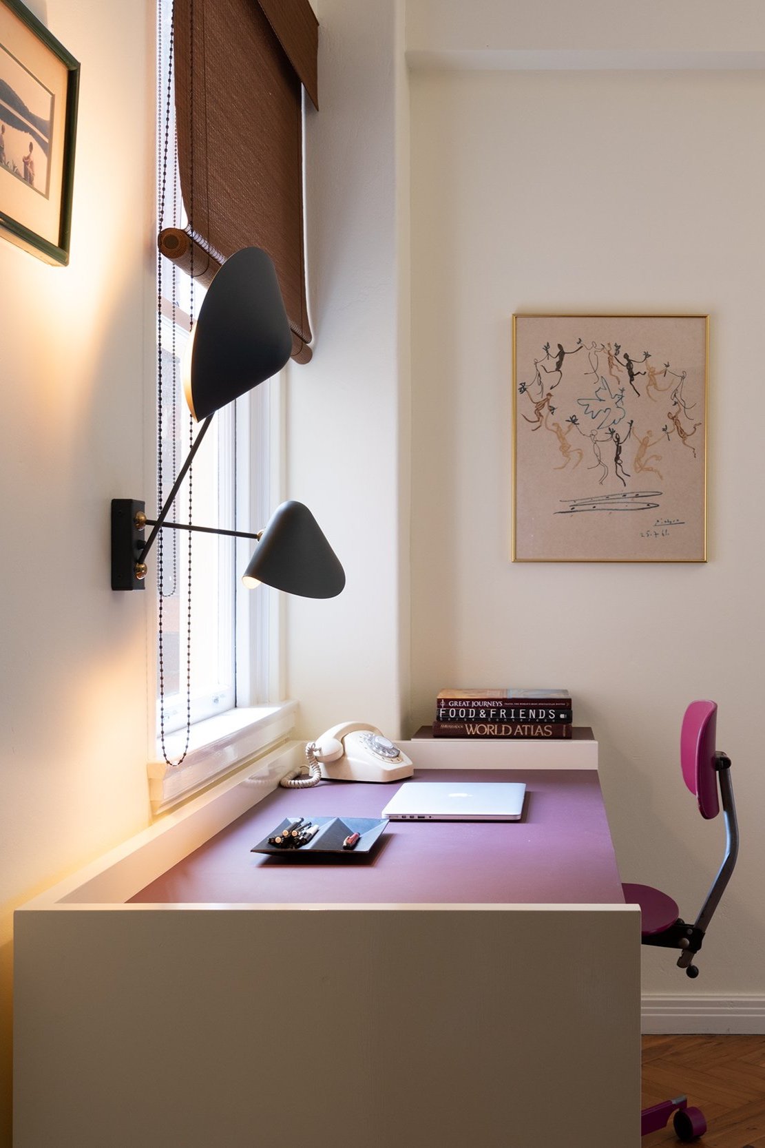 The custom joinery continues in the study, featuring a hand-painted, custom-designed desk tailored to fit the space. French wall sconces add an elegant touch.
