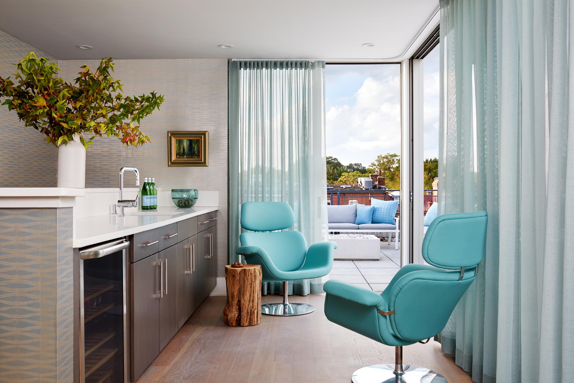Rooftop Lounge Bar with two single stylish swivel chair and white counter top island.