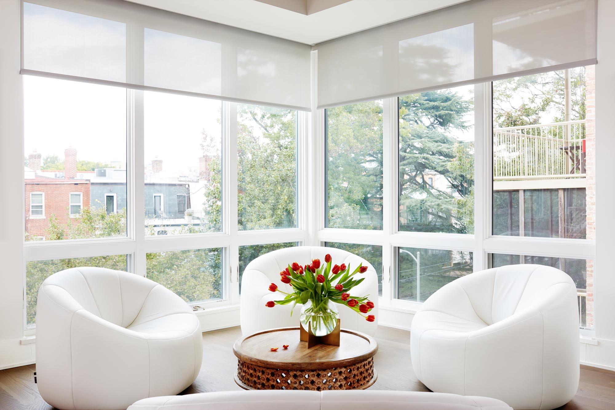 Triangle Design Living Room with Glass walls and Three single white cushion chair