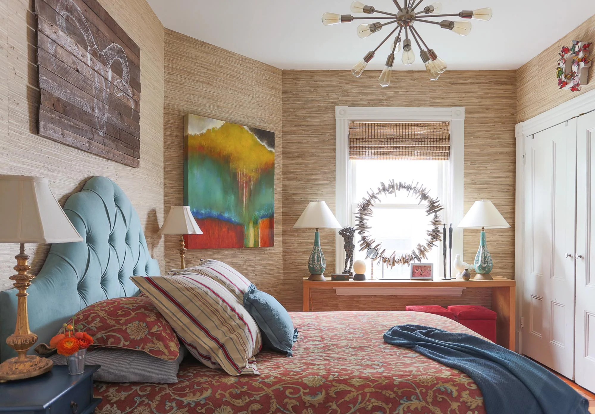 Wooden walled design bedroom with desk lamps and stylish chandelier on the ceiling.