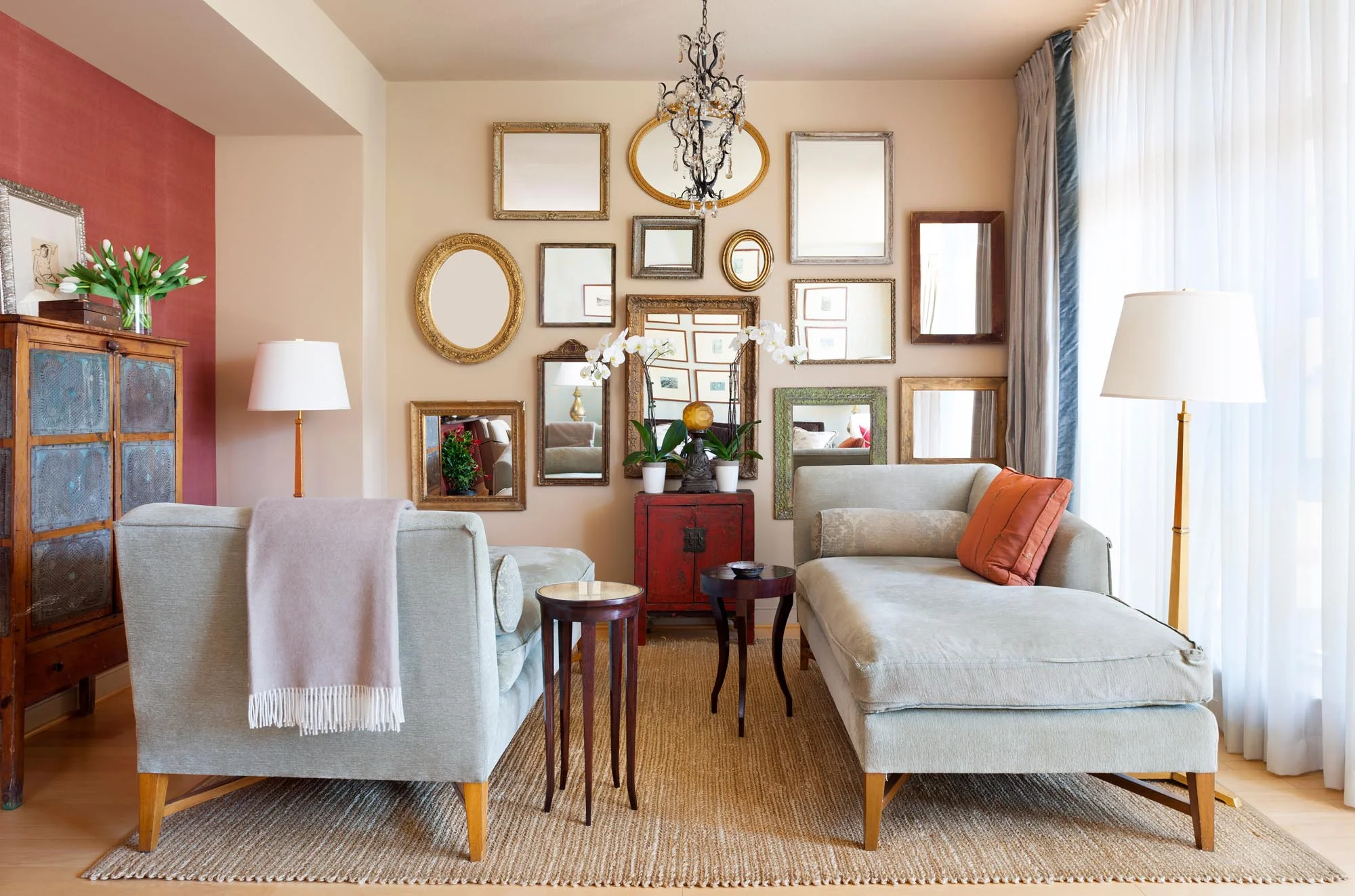 Living Room Design with different mirror designs hanging on the wall, two large sofa day bed and floor lamps