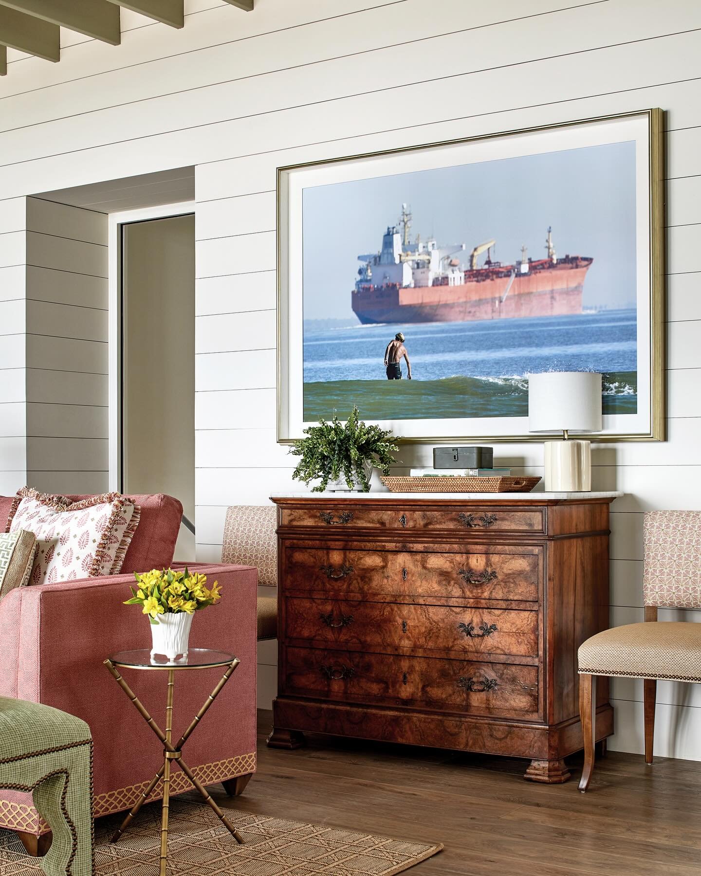 Even while designing rooms with custom furniture, luxurious fabrics, and exquisite detail, Austin did not lose sight of the fact that this is, above all, a family home.

Hanging above an antique chest of drawers in the living room is an enlarged phot