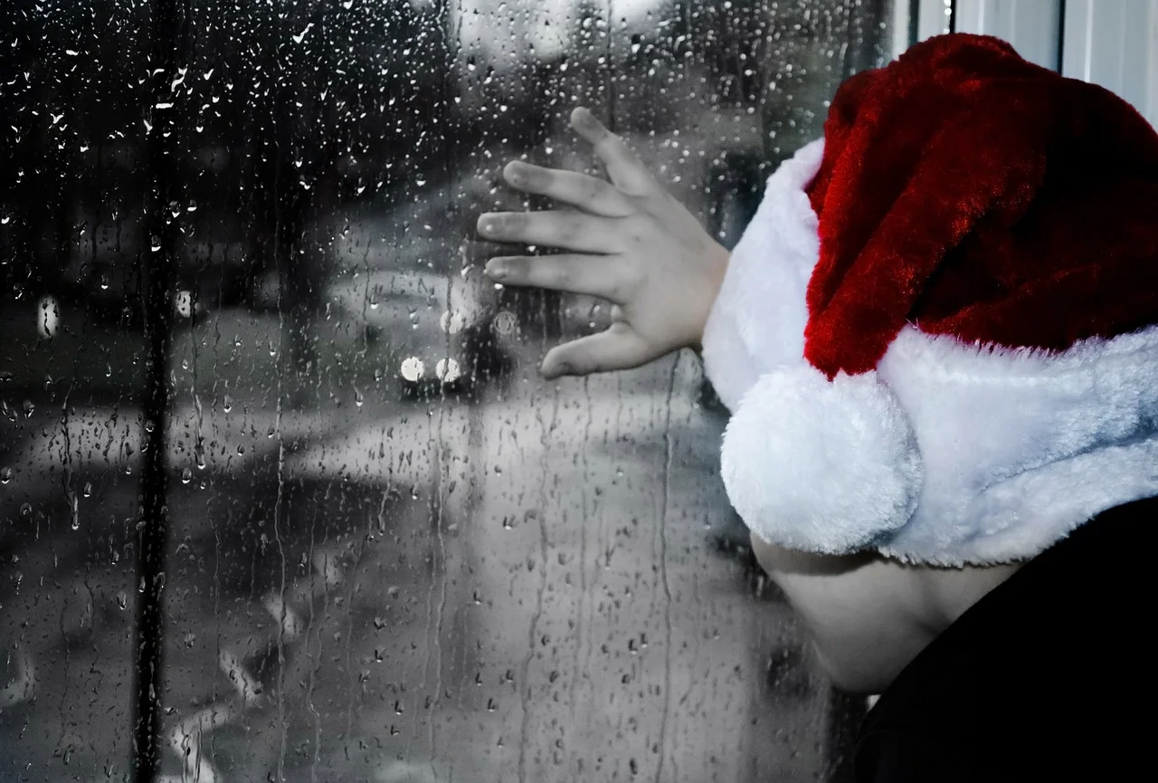 child looking out window to rain family mediation at Christmas.jpg