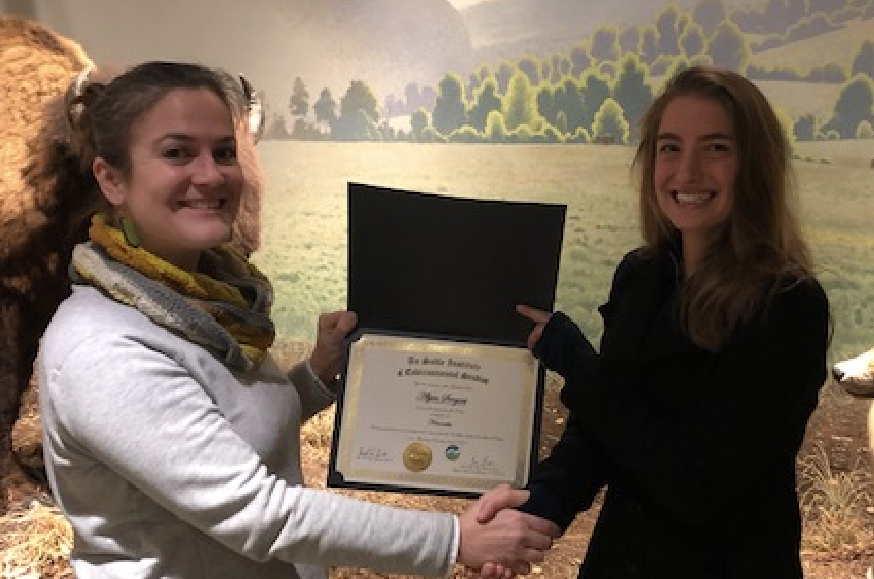 Helena Cicero (left) presents the certificate to Alyssa Sargent (right).