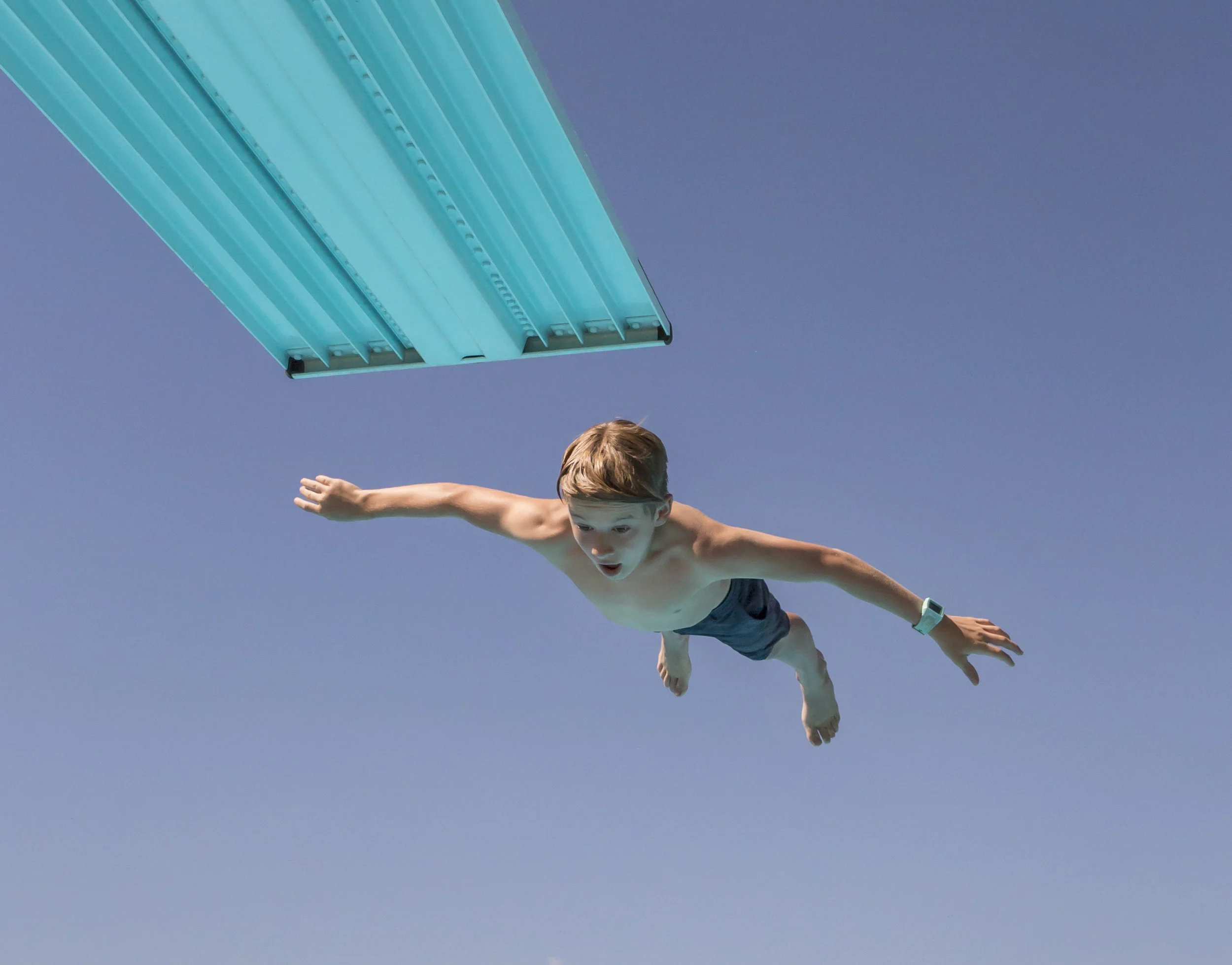  Kanoa Smith, 11, does a flip off of the three meter diving board at Amazon Pool during an afternoon recreation swim in Eugene, Ore. on Tuesday, July 10, 2018. [Ben Lonergan/The Register Guard] - registerguard.com 