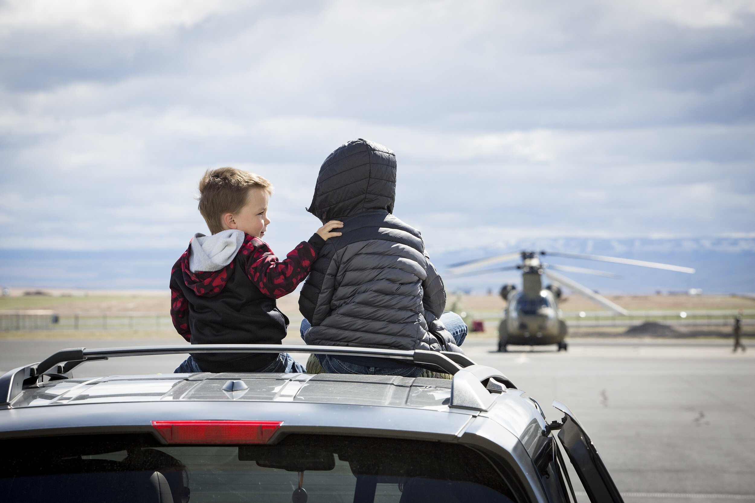  Kasen, left, and Teagan Prine share a moment while sitting on the roof of their mother's car Wednesday, May 6, 2020, at the Oregon Army National Guard Aviation Support Facility in Pendleton. The Prine's father, Staff Sgt. Jeff Prine, was among the d
